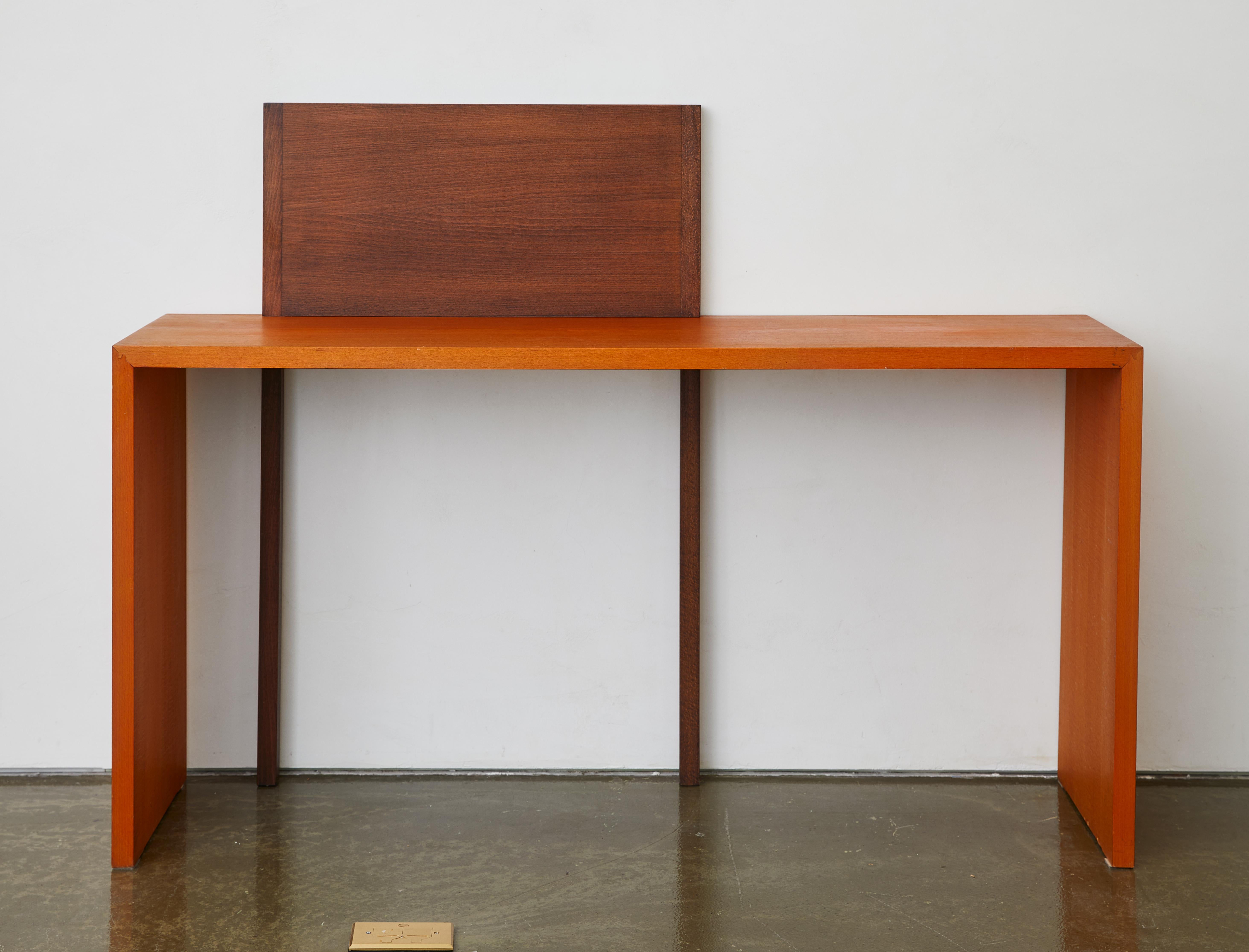 A striking example of late 20th-century Italian design, this console table by Cesare Augusto Nava for Nava Arredamenti blends clean architectural lines with the warmth of wood. Crafted from beech wood with a contrasting light and dark stain, the