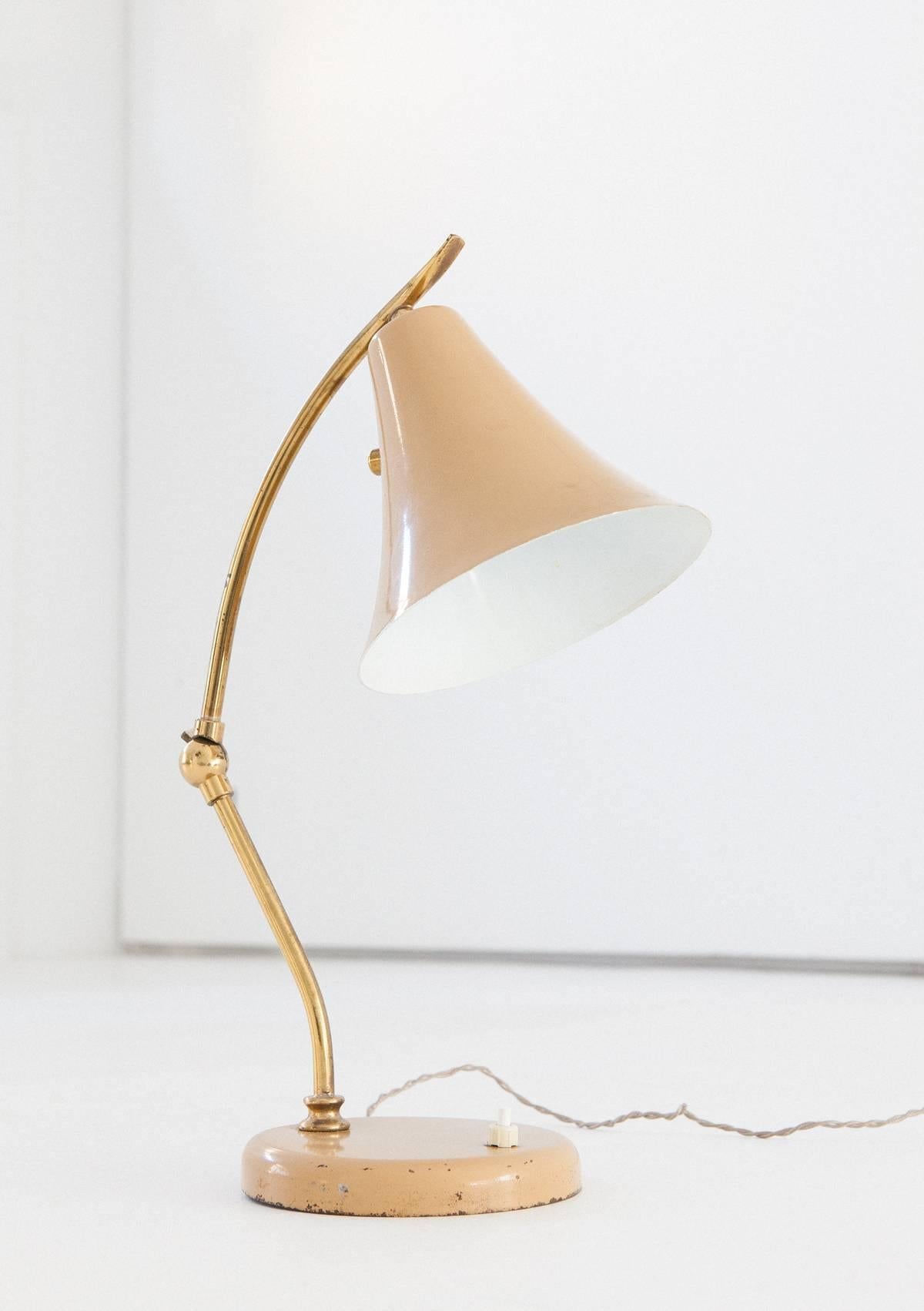 A table lamp manufactured in Italy during the 1950s
Brass frame with a hinge that allows to change the angle and therefore vary the diffuser height

The wire is original and functional but you can ask for a new one.
  