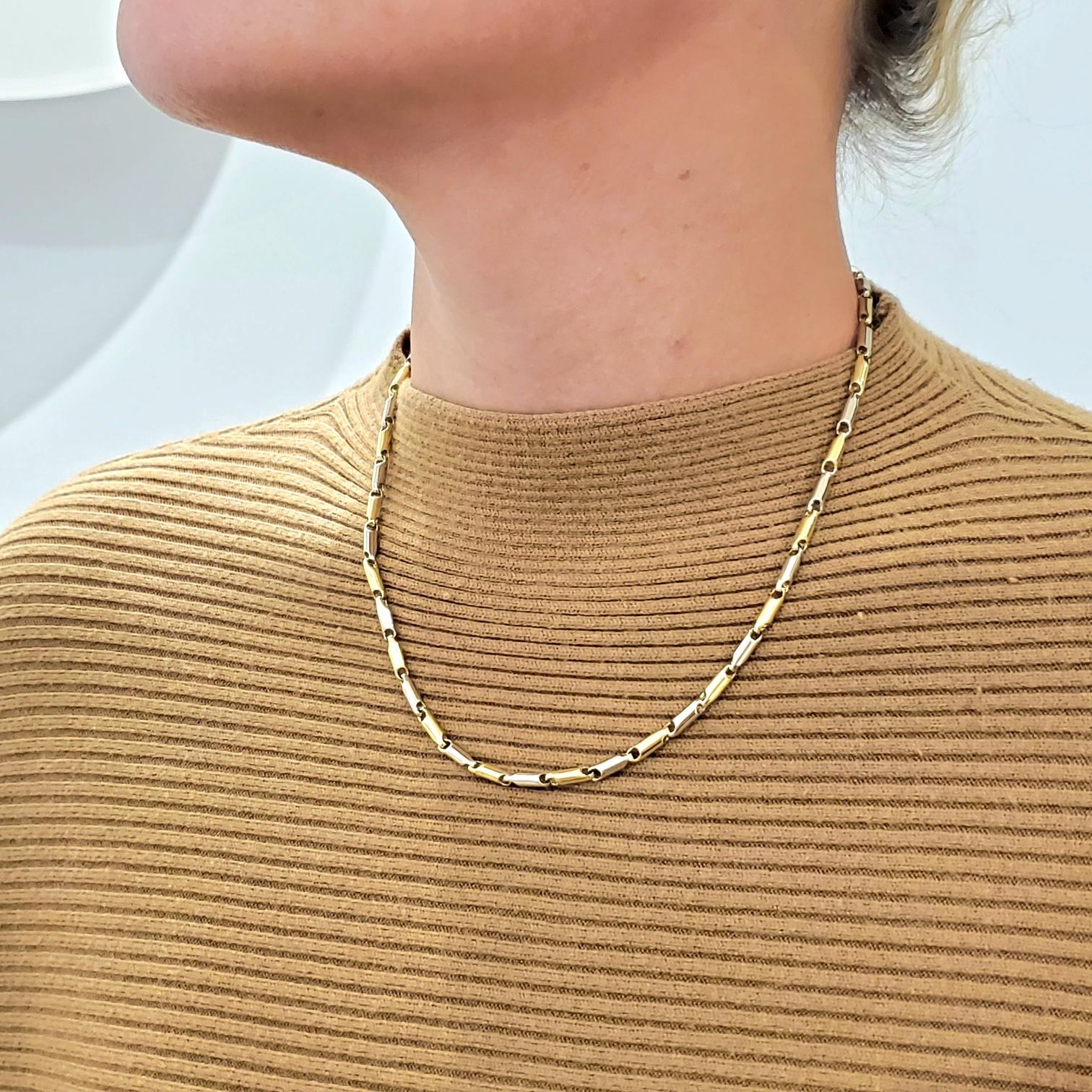 An Italian bicolor chain necklace.

An unusual contemporary bicolor chain, crafted in Vicenza Italy in solid yellow and white gold of 18 karats. The design is composed bt 45 tubular elements alternating in white and yellow and fitted with a fancy