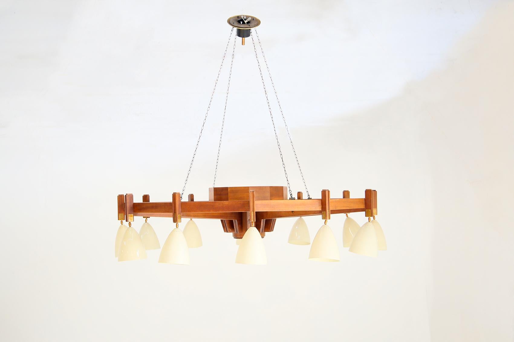 Beautiful and very large 1950s Italian midcentury Chandelier in BBPR Studio style. The large chandelier features a noble wood frame with straight, clean lines and a round shape. The chandelier features 13 lights including a central one and 12