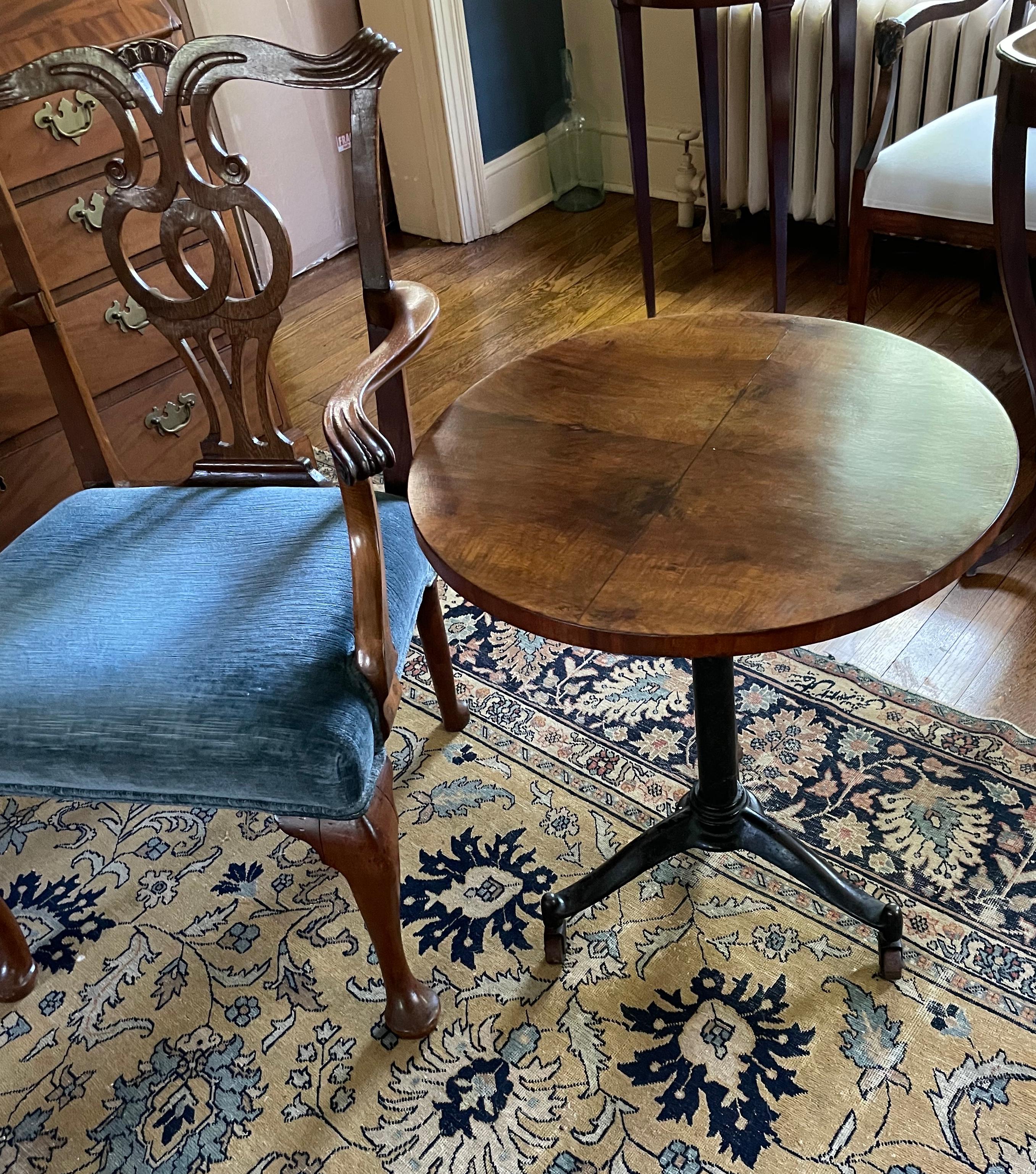 Italian bistro table. Vintage Deco era mahogany topped circular bistro table on black metal pedestal on tripod legs eith original mahogany casters. Italy, first quarter twentieth century 
Dimensions: 21.75