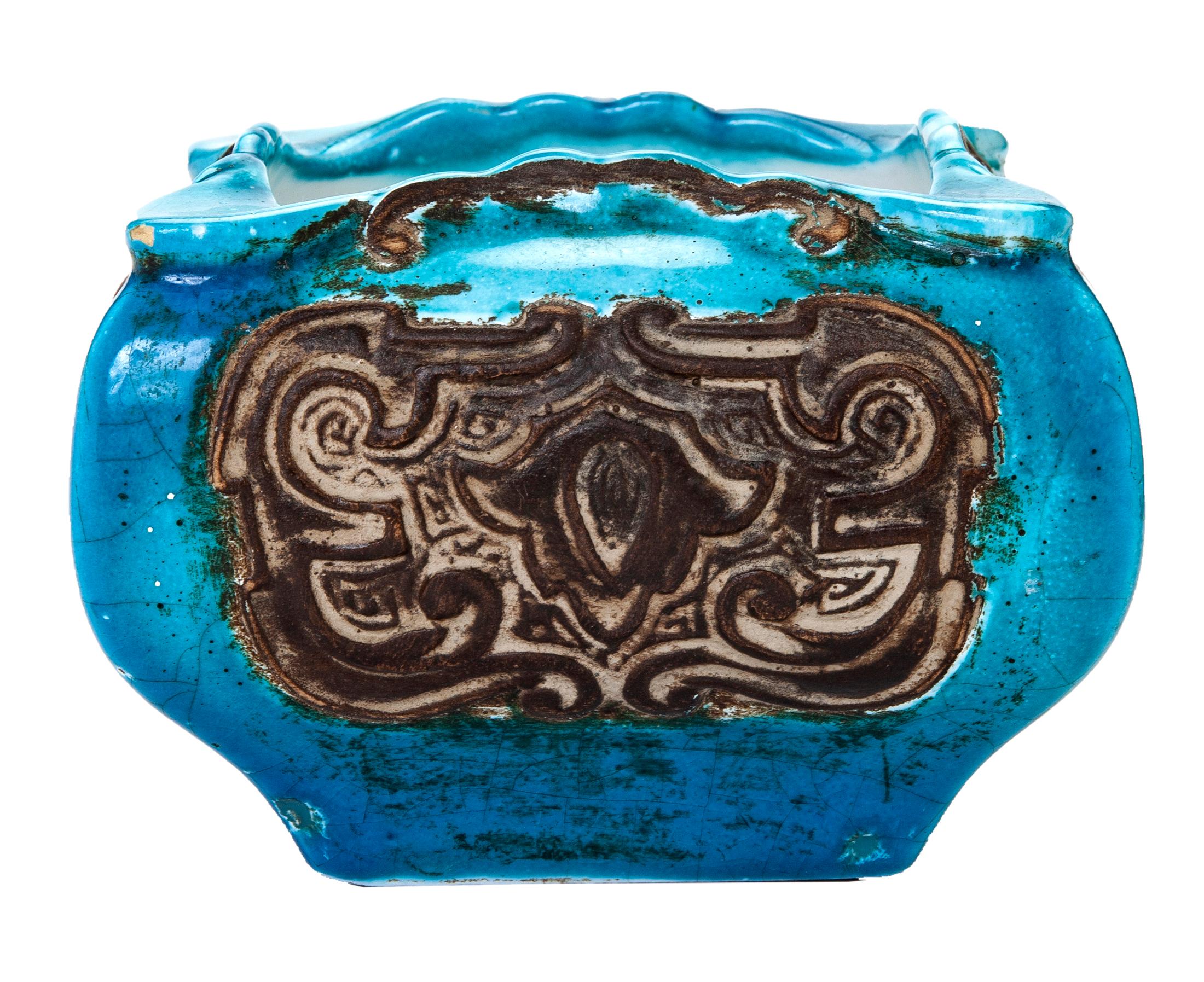 Charming Italian vessel, use as small planter ashtray or catchall. The huge is a brilliant shade of aqua, accented in a terra cotta brown with an attractive embossed design.
Created by Bitossi Rimini. Made in Italy