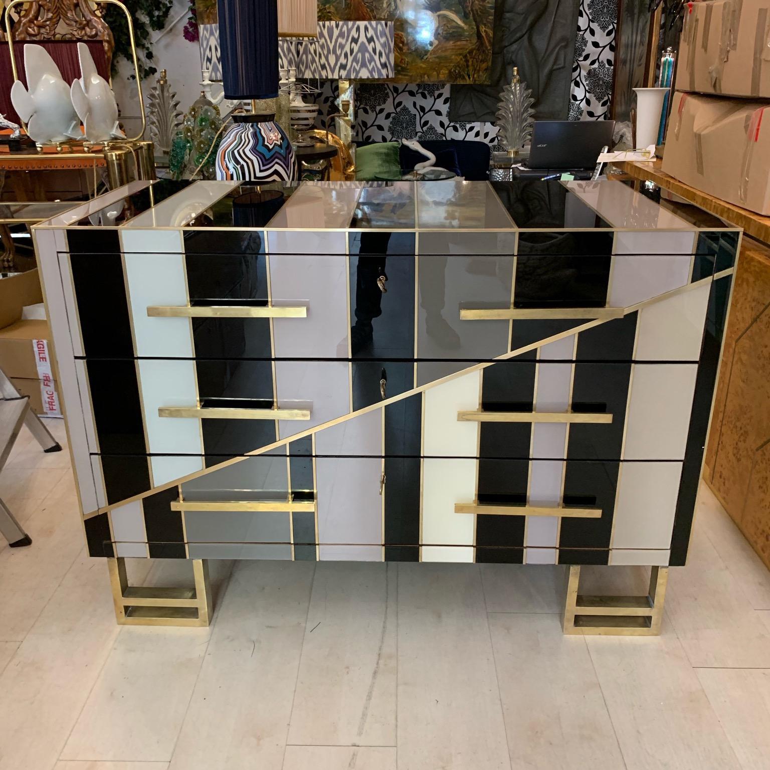 Black and ivory striped Opaline glass chest of drawers the multicolored Opalines glass (black, ivory, grey, dove gray color) form a geometric design on the front and on the top, the sides are in black Opaline glass. The chest has three drawers,
