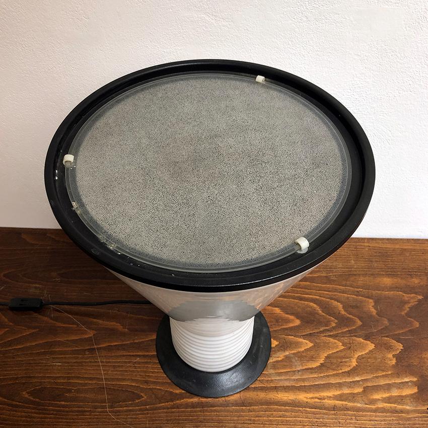 Italian black enameled metal and opaline glass table lamp, 1970s. Table lamp with structure in opal glass, knurled in the lower part and parts in black enameled metal. The upper disc is in satin glass. Very good condition.