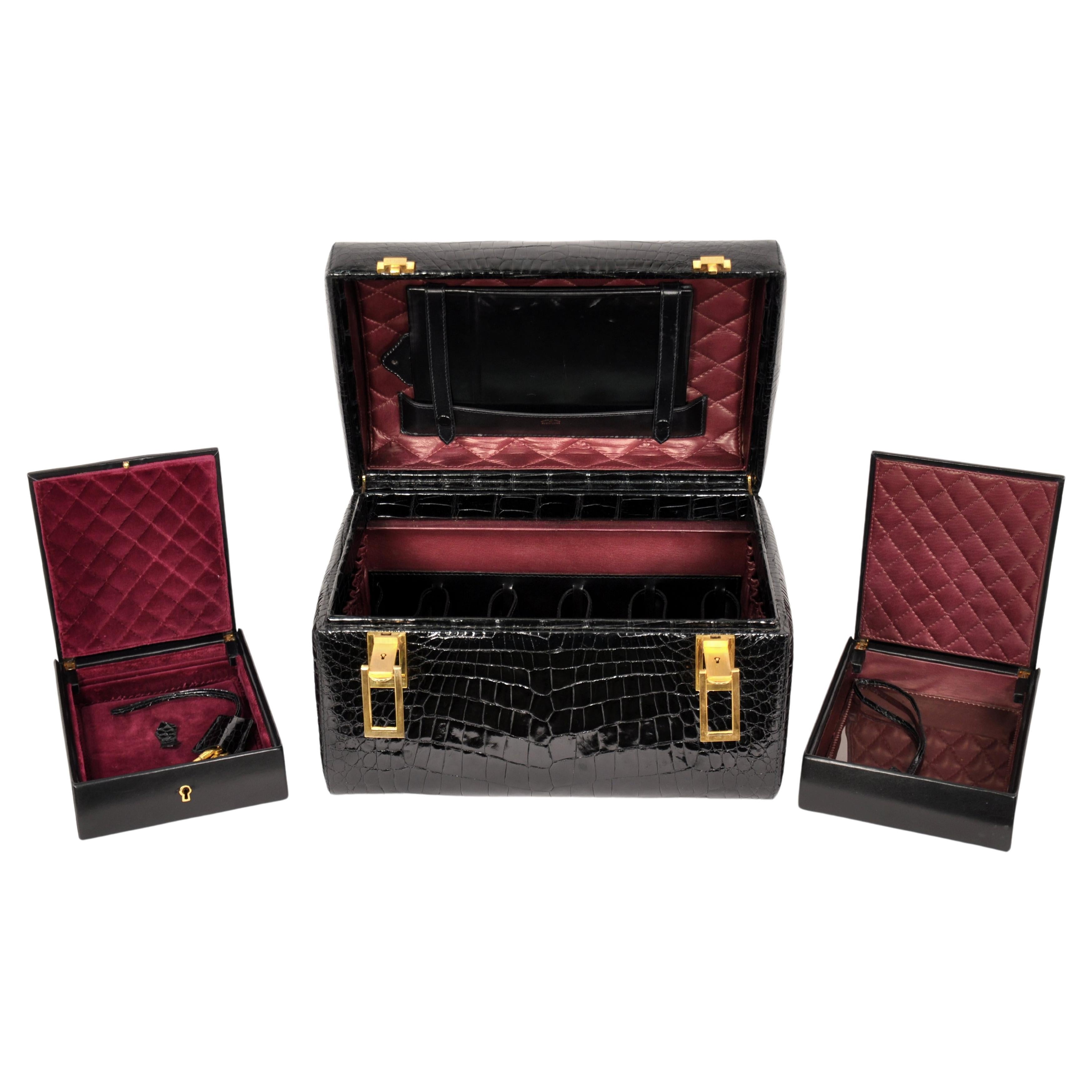 Embrace elegance and style with this extremely rare, genuine black crocodile train case by Revlon. The mint condition beauty and jewelry case features a perfectly shiny black crocodile exterior with brass hardware, accents and feet. The luxurious