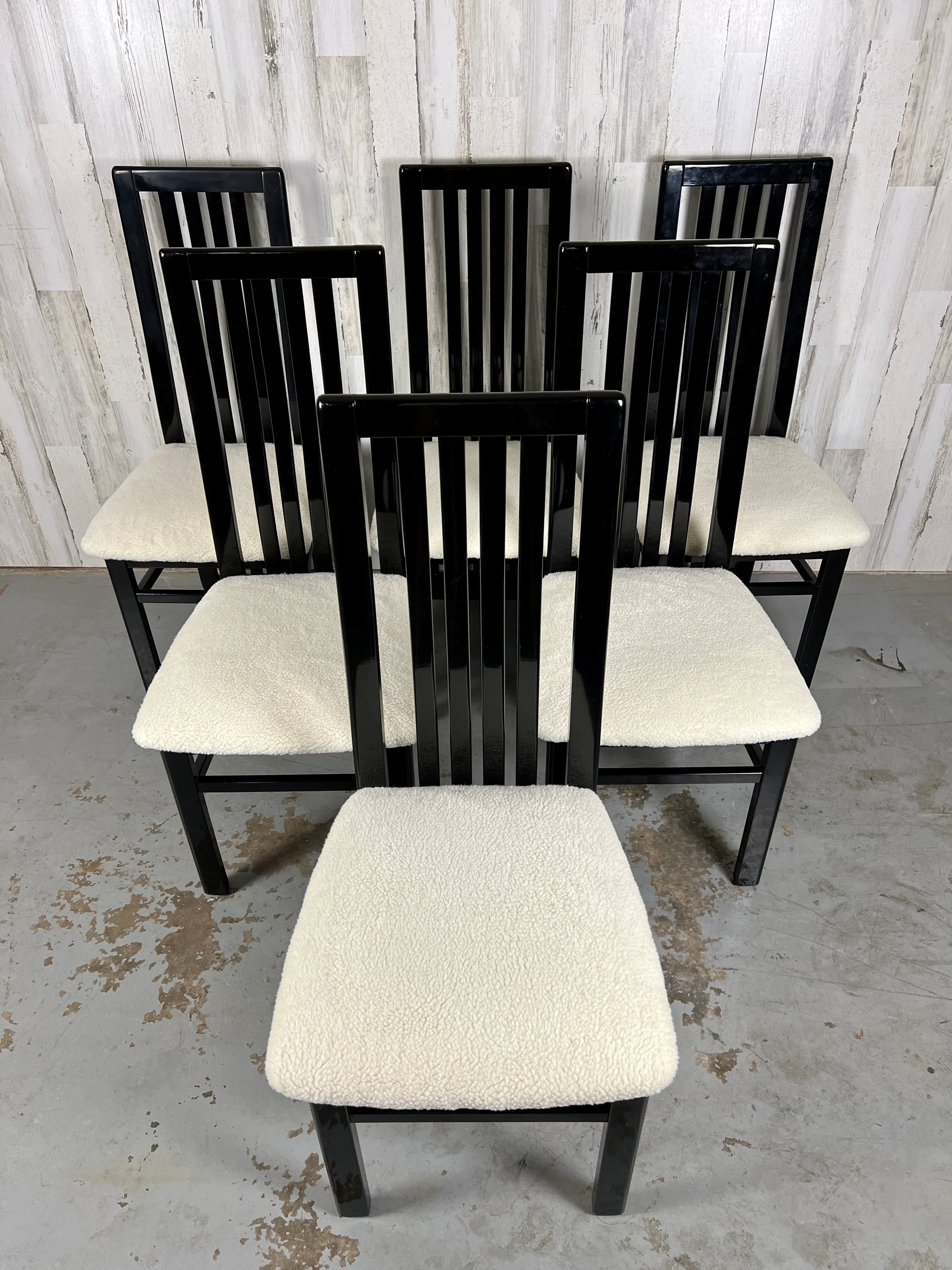 Italian black lacquer dining chairs by S.P.A Tonon. High back curved chairs with a new fuzzy ivory Sherpa fabric on the seats.