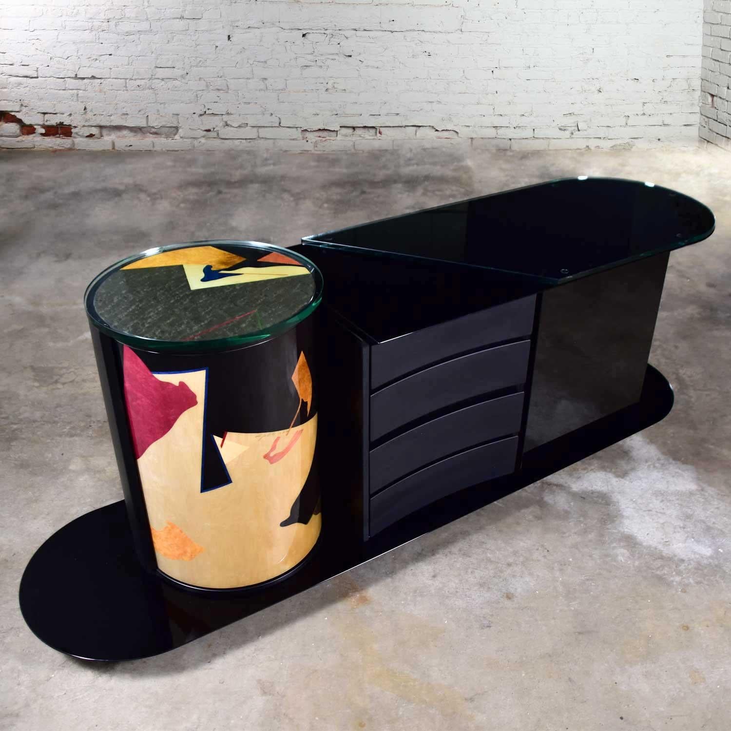 Stunning postmodern Italian black lacquered buffet, credenza, or sideboard signed by Pietro Costantini. Comprised of a highly lacquered black finish, cylinder shaped unit on one side with abstract geometrical designs in gold, green, red, blue, and