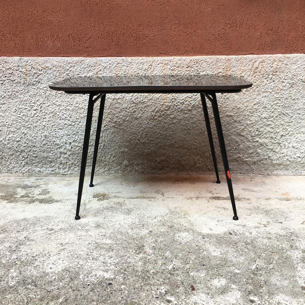 Italian black laminate and metal rod folding coffee table, 1960s
Folding black laminate coffee table, with rounded corners and folding structure in black metal rod.
Produced by Alborgomma of Bergamo, 1960s.
Good general condition, with some