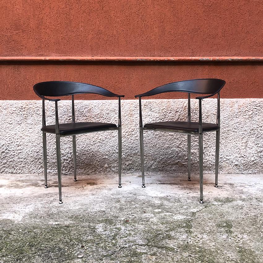 Italian black leather and chromed steel chairs, 1970s. Set of 2 beautiful Italian dining chairs, with armrests, seat and back in black leather and chromed steel structure. Very good general conditions.