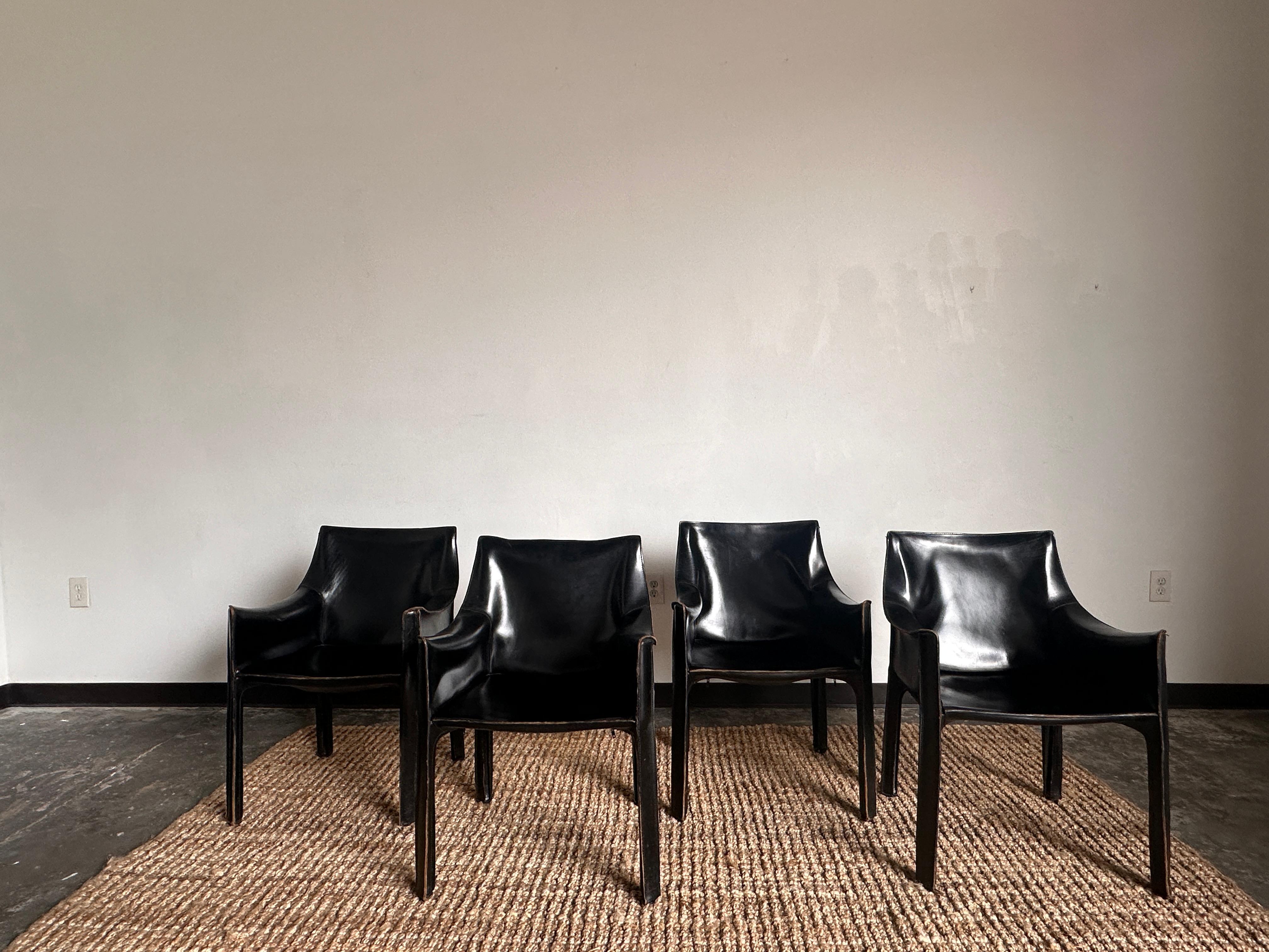 4 chairs available. Price is per chair.

Black saddle leather with zippers along legs, steel frame painted black with plastic shell seat. The chairs are in excellent original condition with minor age-appropriate wear. One of the most iconic chairs,