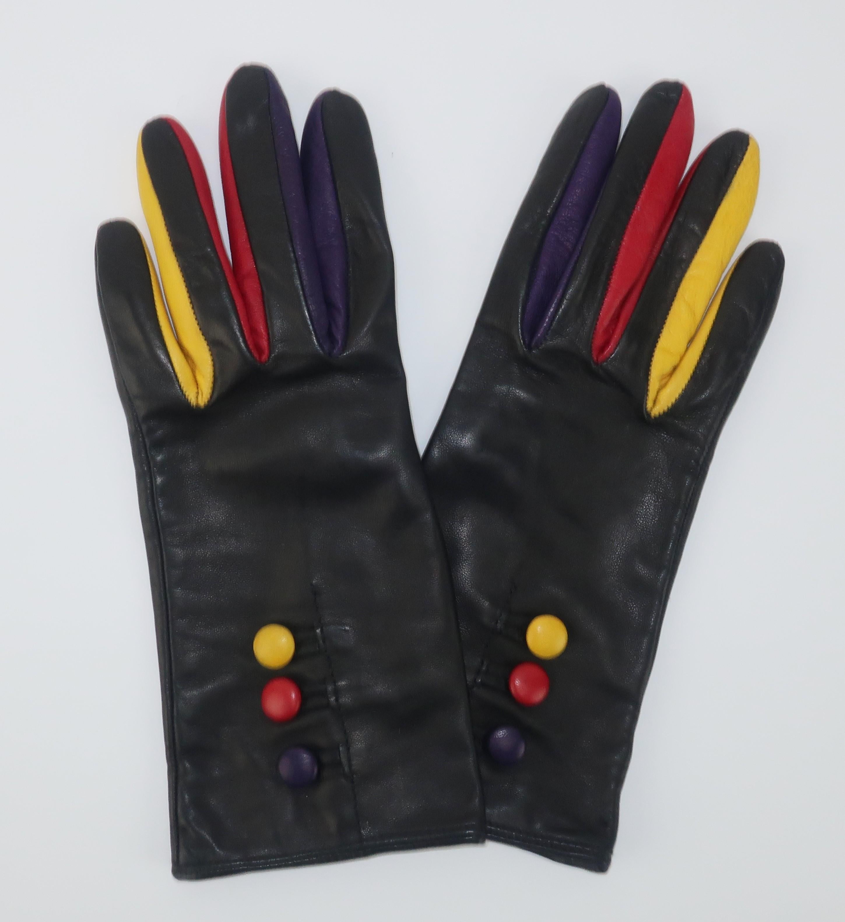 Sergio Di Cori Italian black leather gloves accented by purple, red and yellow leather inserts between the fingers and buttons at the cuffs.  Lined in a soft lightweight wool and finished with a vent at the cuffs.  From the Atlanta estate of