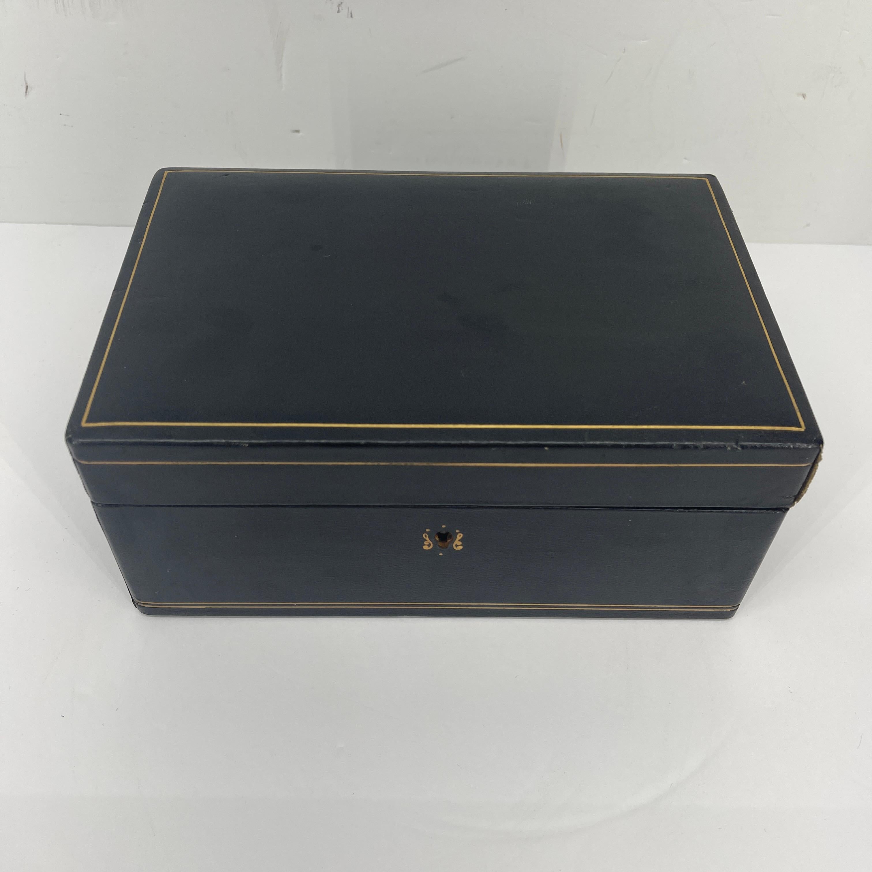 Mid-Century Modern black leather jewelry box. Sweet petite jewelry box in butter soft black leather with red felt interior. This little box is a wonderful addition to your vanity or dressing table. In very good condition, the leather is soft and the