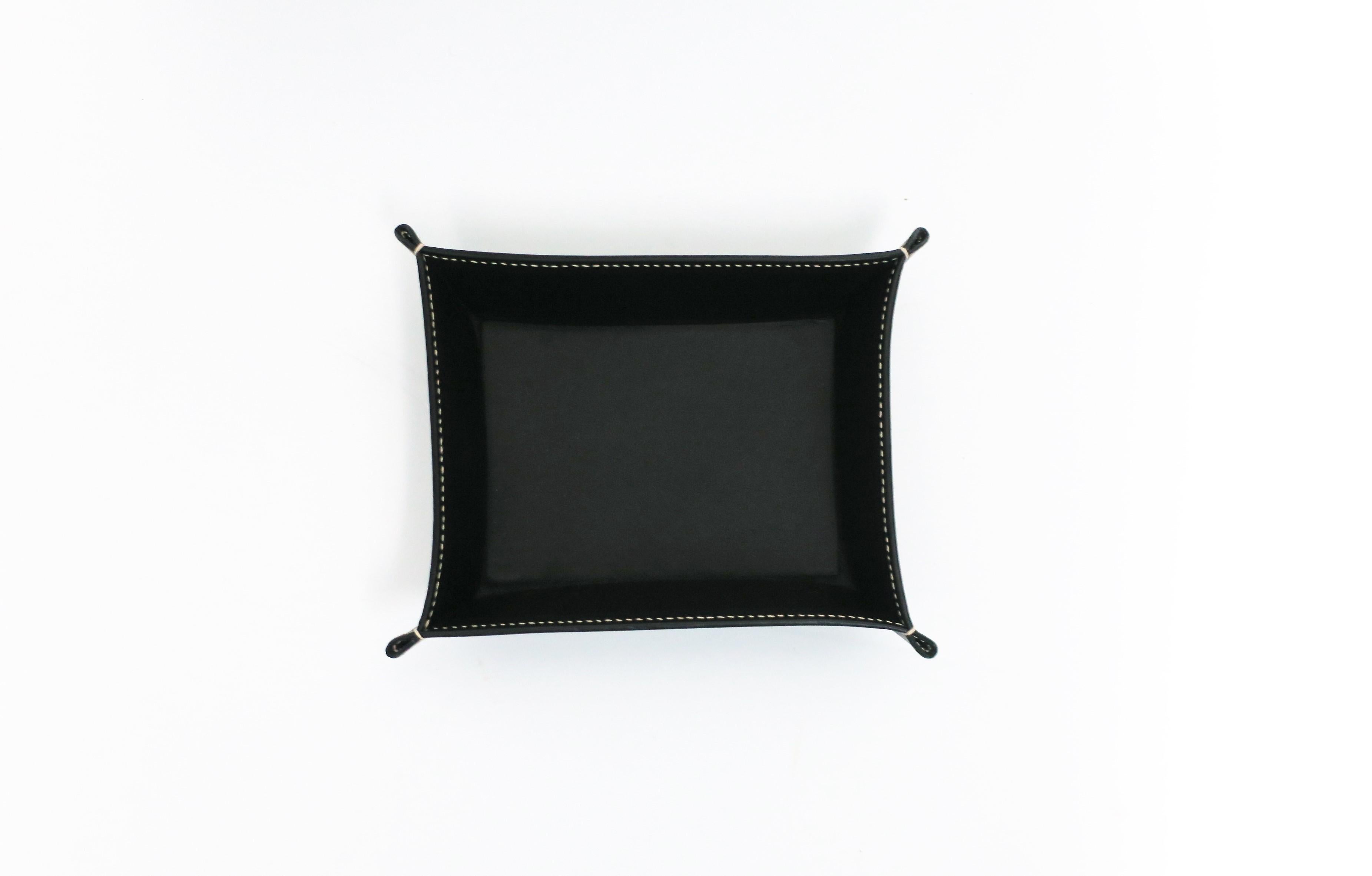 An Italian black leather jewelry or trinket catchall tray with white thread detail on corners, circa early 21st century, Italy, for Bergdorf Goodman, New York. Piece was made expressly for 