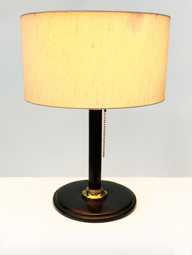 Italian black stitched leather table lamp

A table lamp with stitched leather, with its original shade. (black leather on top)
The shade has some small traces of use, but nevertheless ready for daily use. 
The leather is beautiful and in very good