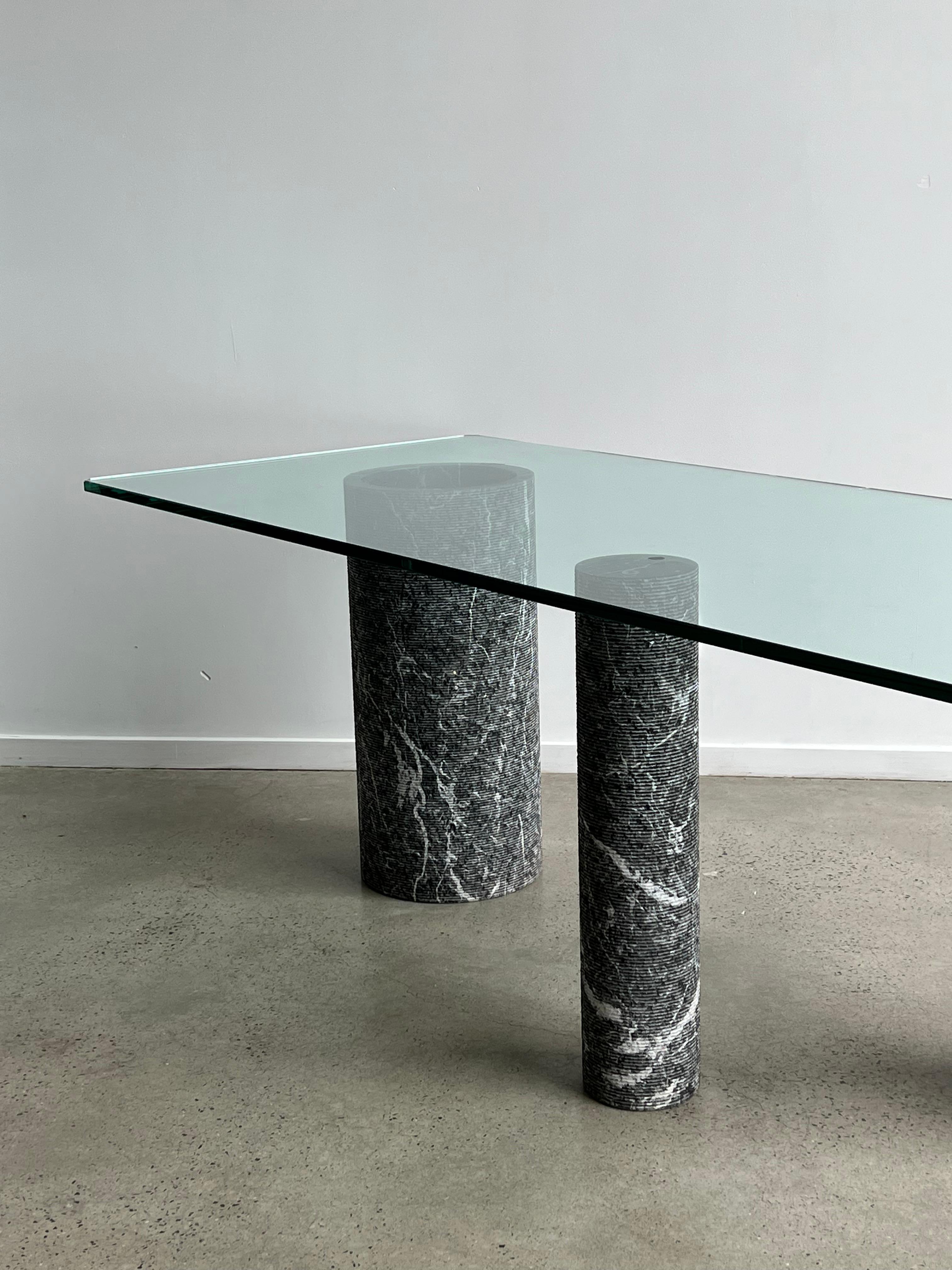 Amazing clean lines and beautiful materials used to design this stunning table in black marble and crystal glass 
Massimo Vignelli Highlight the simplicity but striking with this breathtaking pieces of art.
Design By Massimo Vignelli and