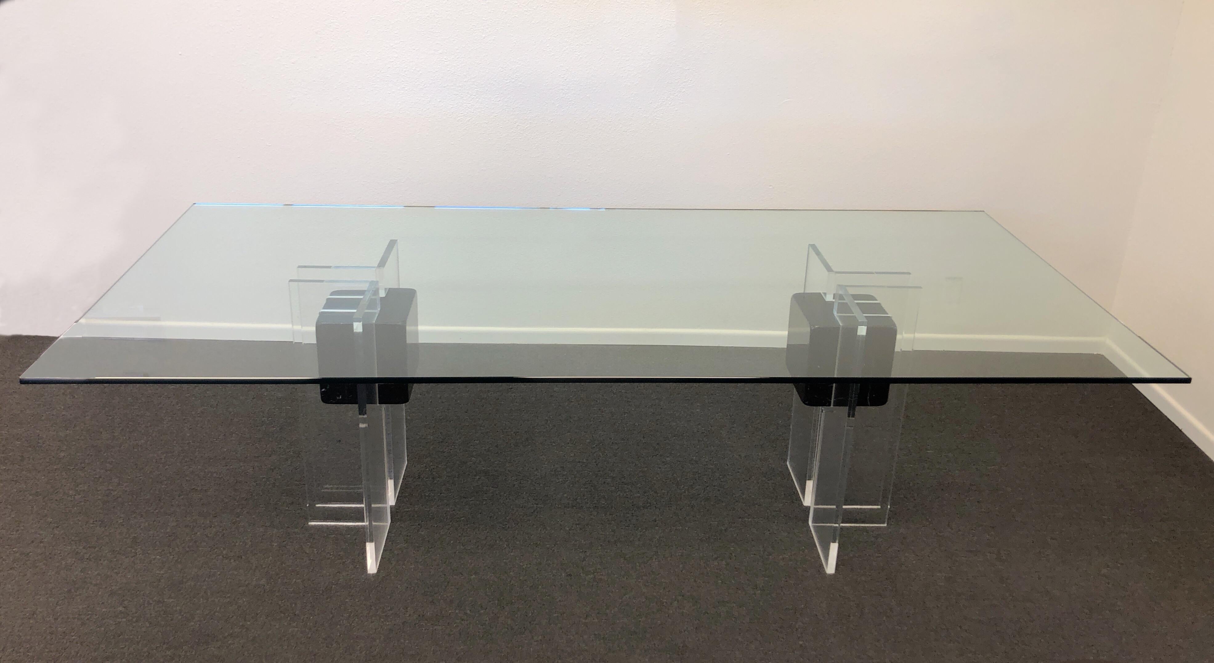 A beautiful 1980s Italian clear Lucite and polish black marble with a glass top. The acrylic and marble has been newly professionally polished. The top is the original 5/8” thick glass. The bases are available without the glass top.
Dimension: