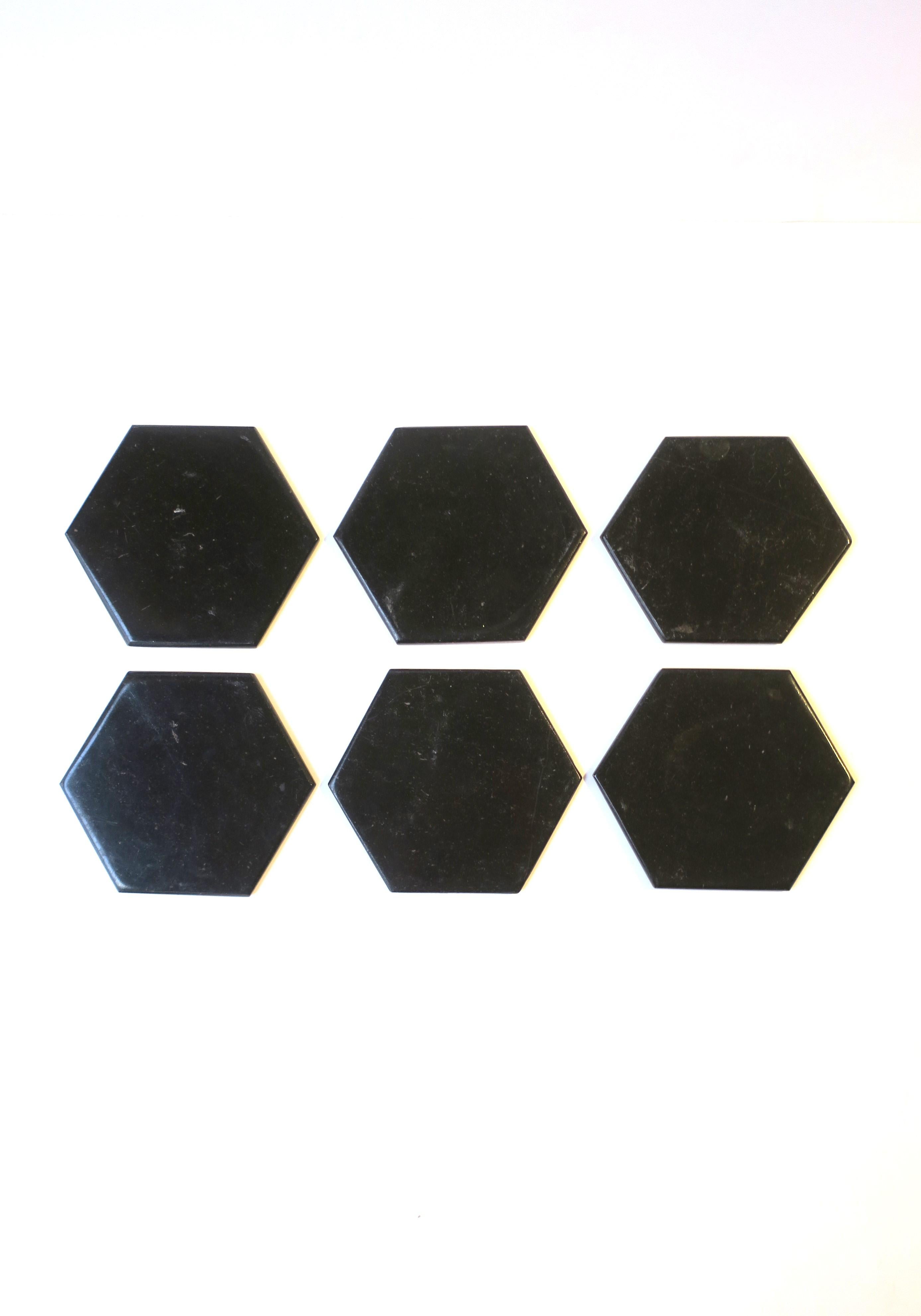 A great set of six (6) Italian jet black marble stone hexagon cocktail or drinks coasters, with holder, in the Modern style or Postmodern period, circa 1970s, Italy. The hexagon shape is a great alternative to round. Set includes 6 marble coasters