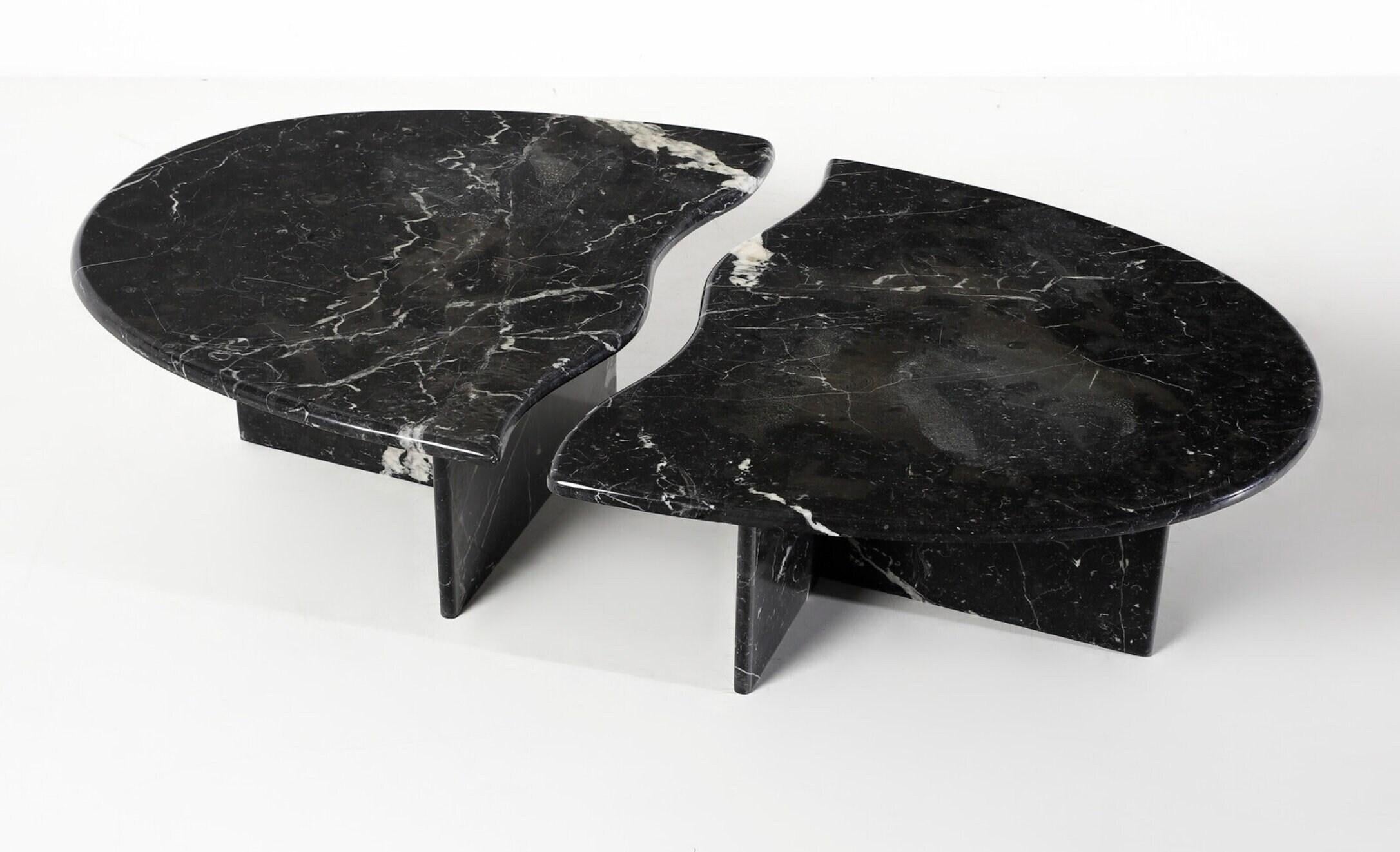 The wavy split coffee table is the eptiomy of dynamic Italian design of it’s times. Marquina is a black marble with subtle white veins.

This unit is in perfect condition with no blemishes and could be used as two side console tables.

The