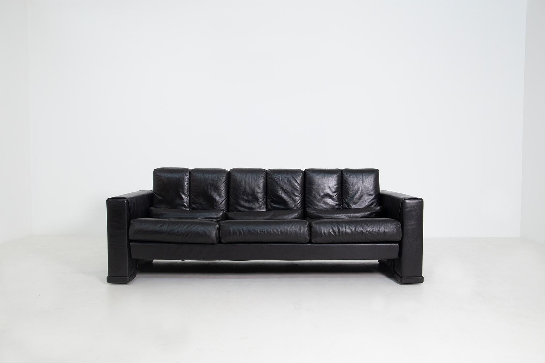 Modern Italian sofa designed by Mario Bellini for B&B Italia in 1985. The sofa is entirely covered in black leather with a steel frame with special profiles. The padding is in cold polyurethane foam. The peculiarity of the sofa are its perforated