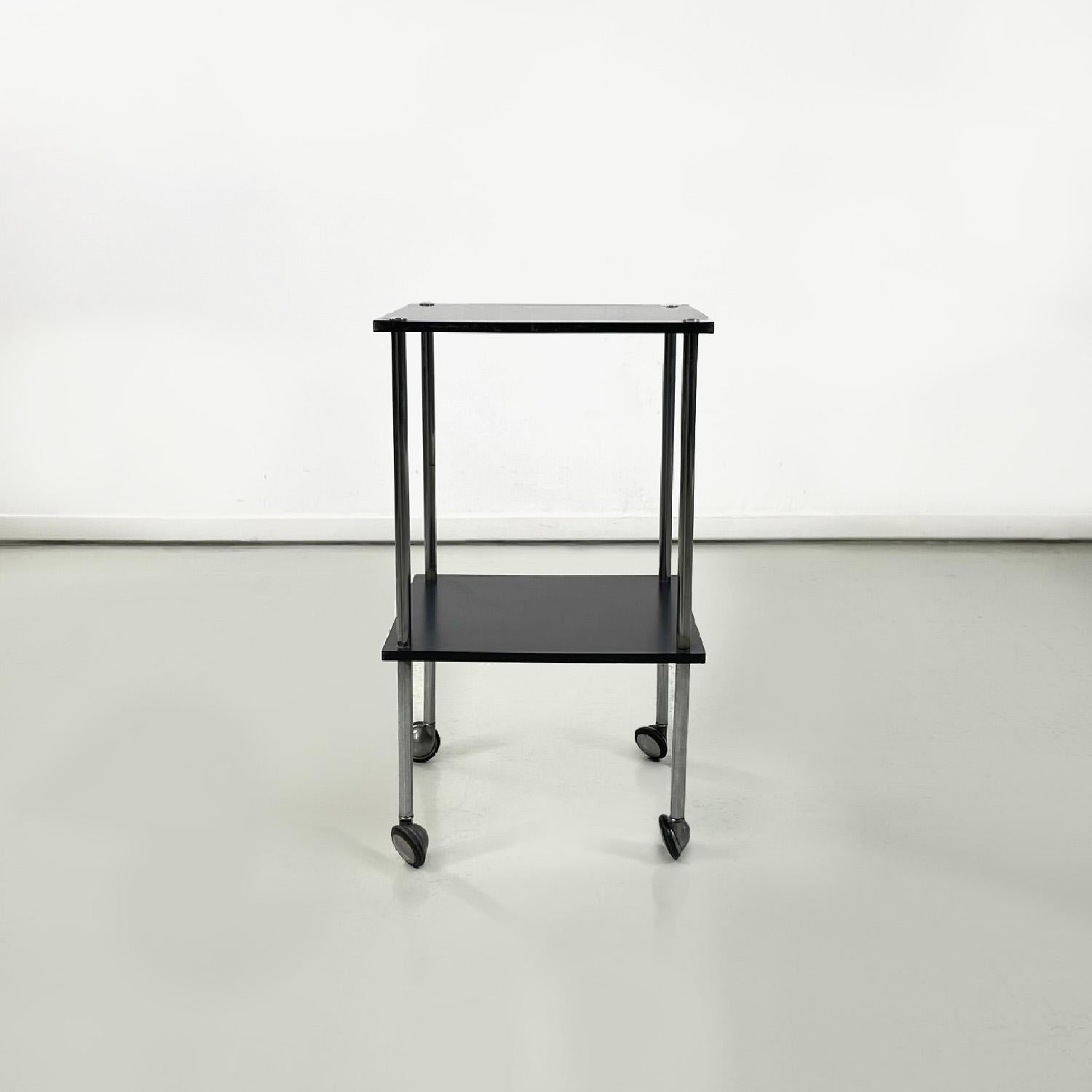 Italian black trolley on wheels T9 by Luigi Caccia Dominioni for Azucena, 1960s
Trolley or coffee table mod.T9 on wheels. It has two black lacquered rectangular tops, the structure is in chromed steel. The legs have a circular section, the wheels