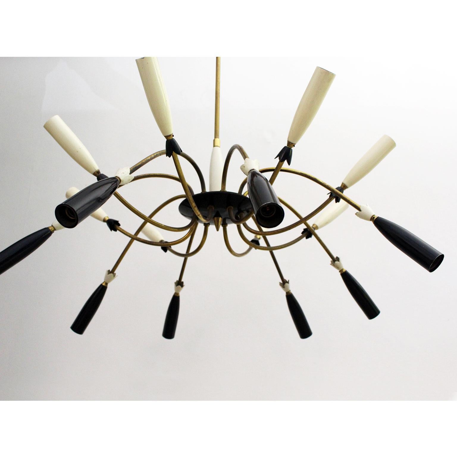 This incredibly chic Italian pendant is very much in the style of Stillovo. It comprises sixteen-light arm, eight black tipped, and eight white tipped. The arms splay out from a central brass pillar and black circular housing. Wonderful paired with