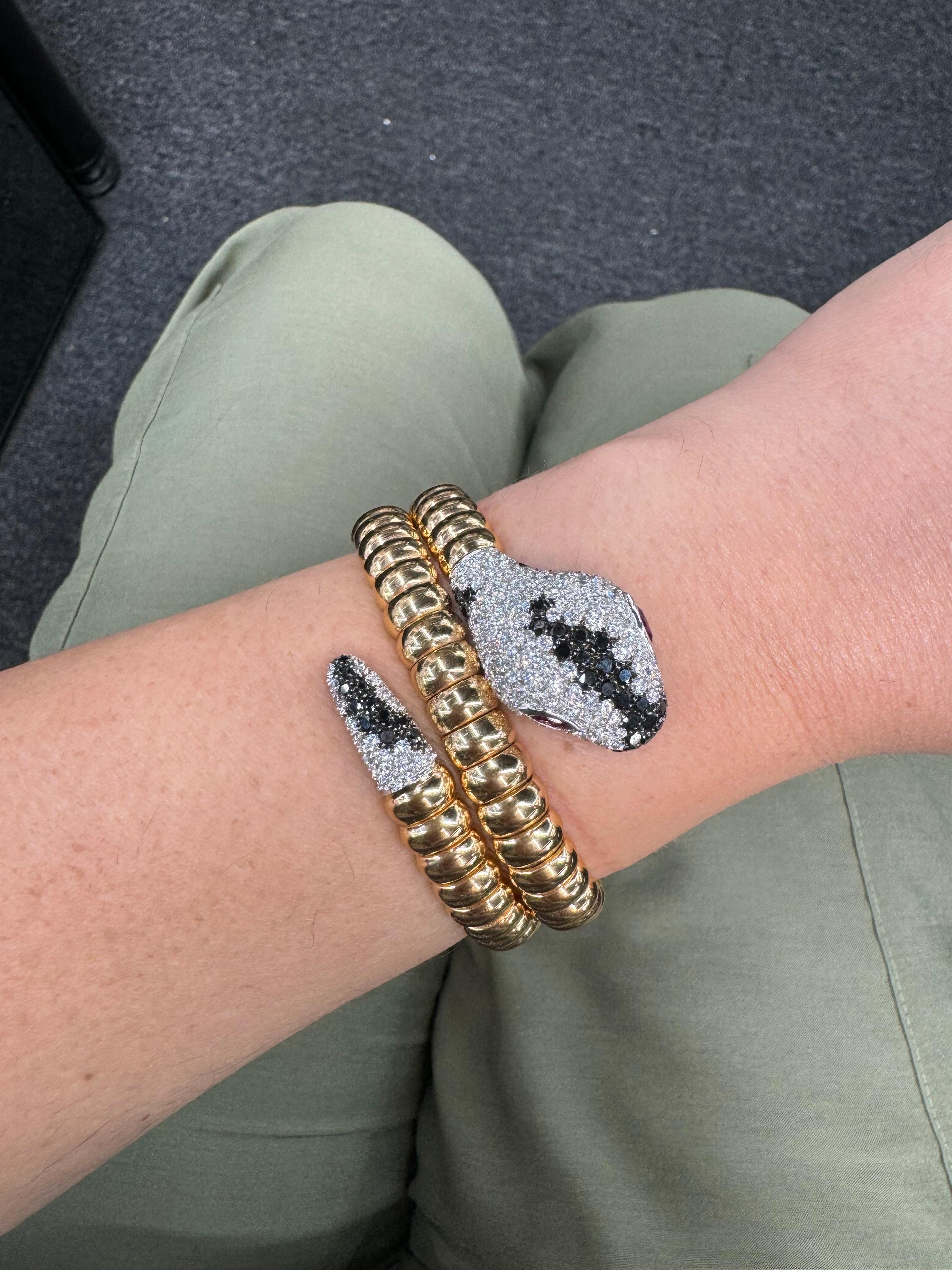 Gorgeous 18 karat rose gold wrap bangle bracelet featuring numerous black and white round brilliance weighing 106.1 grams.
Super chic & a such a conversation piece!  
More snake bangles in stock. 

Approximately 6 carats of white diamonds. 
Ruby
