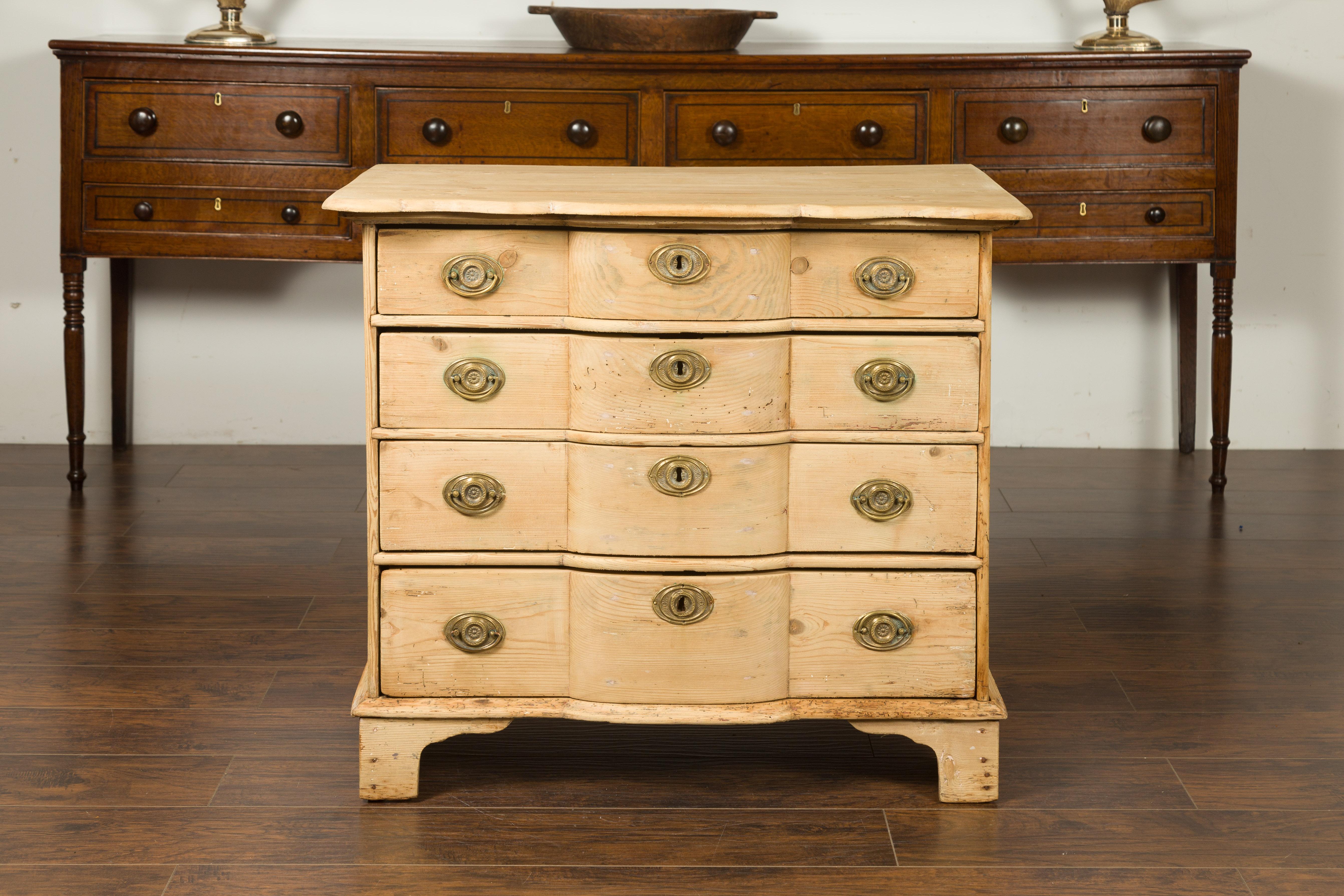 An Italian freshly bleached pine commode from the early 19th century with serpentine front. Born in Italy during the first years of the 19th century, this chest-of-drawers features a rectangular top, curved in the front, nicely following the shape