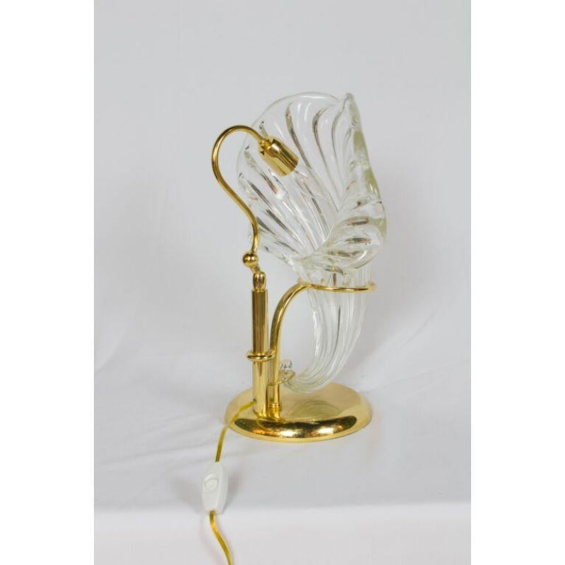 Italian Blown Glass and Gold Lamp.Clear blown glass. Bright gold metal finish on metals. Rewired and in excellent condition. Italian, C. 1980.  80's Deco

Dimensions: 
Width: 13″
Depth: 10″
Height: 16″