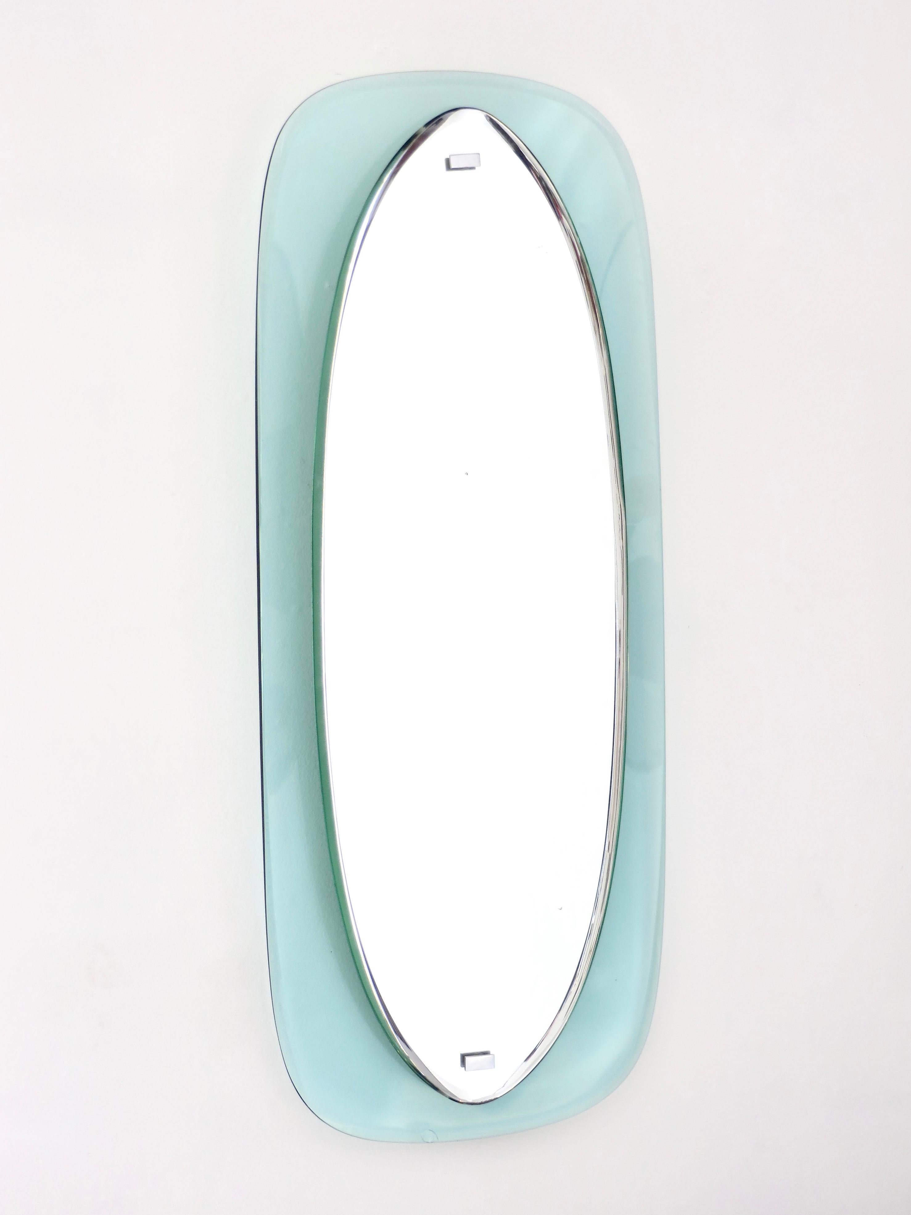 Oval Italian pale blue framed colored floating crystal beveled glass frame mirror with original looking glass by crystal Arte Circa 1960. 
In the shipping of this mirror there occurred a small éclat or conchoidal chip inside of the glass at the