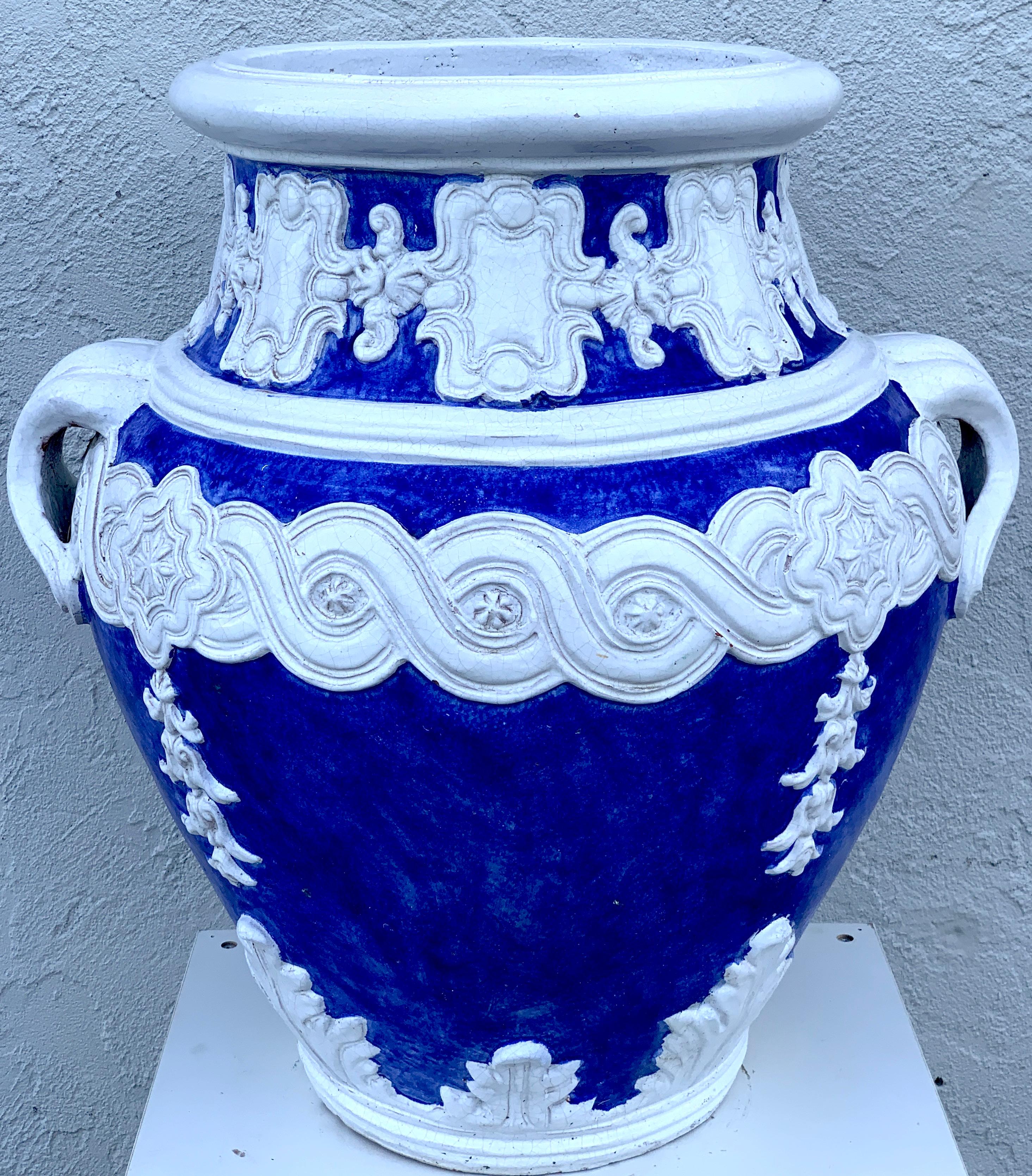 Italian blue and white Della Robbia style jardinière, Provenance, Celine Dion
Of large scale the two handled urn with white appliqués on a Tuscan blue background. Can be used indoors or outside. The opening diameter is 16.5