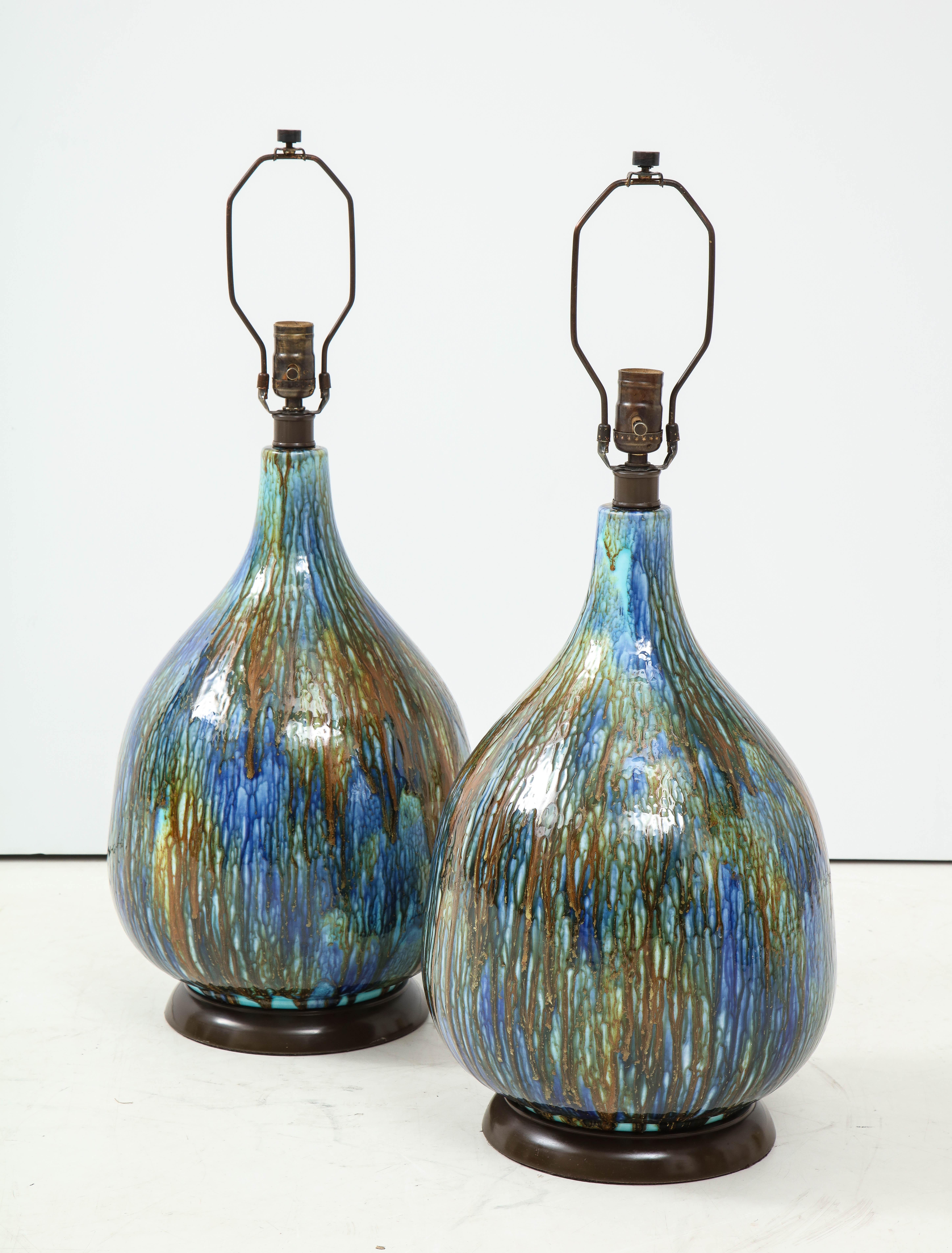 Pair of Italian midcentury blue, brown drip glazed ceramic lamps on enameled bases. Rewired for use in the USA, 100W max bulbs.