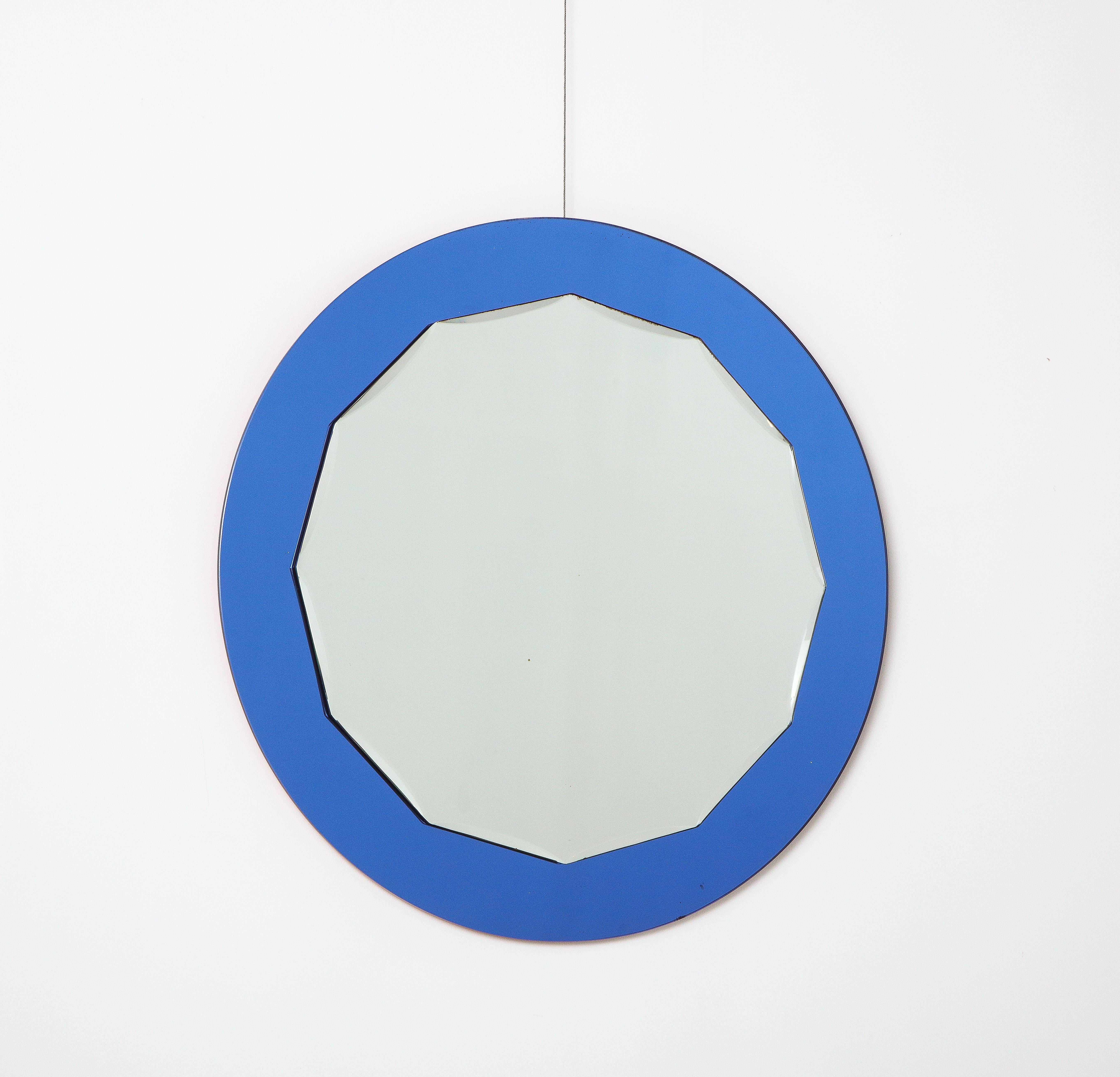 Ein runder italienischer Spiegel aus den 1950er Jahren mit blauem Rahmen und klarem, geschliffenem Glas im Innenteil. 
Italien, um 1950 
Größe: 28