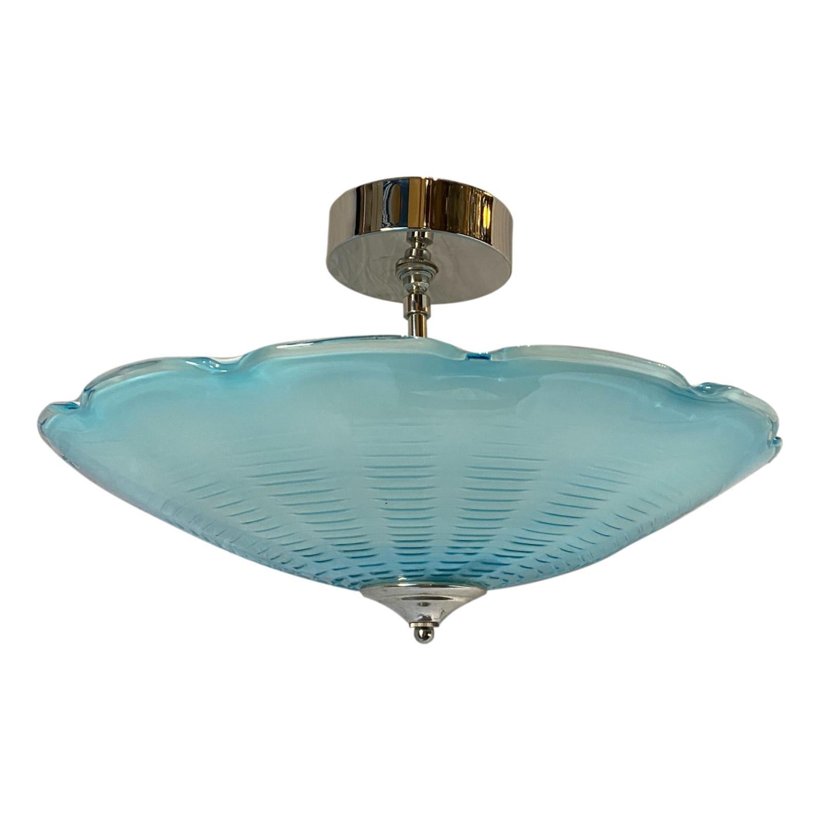 A circa 1930s semi-flushed pendant blue blown glass light fixture with three interior candelabra lights.

Measurements:
Height 10?
Diameter 19?.