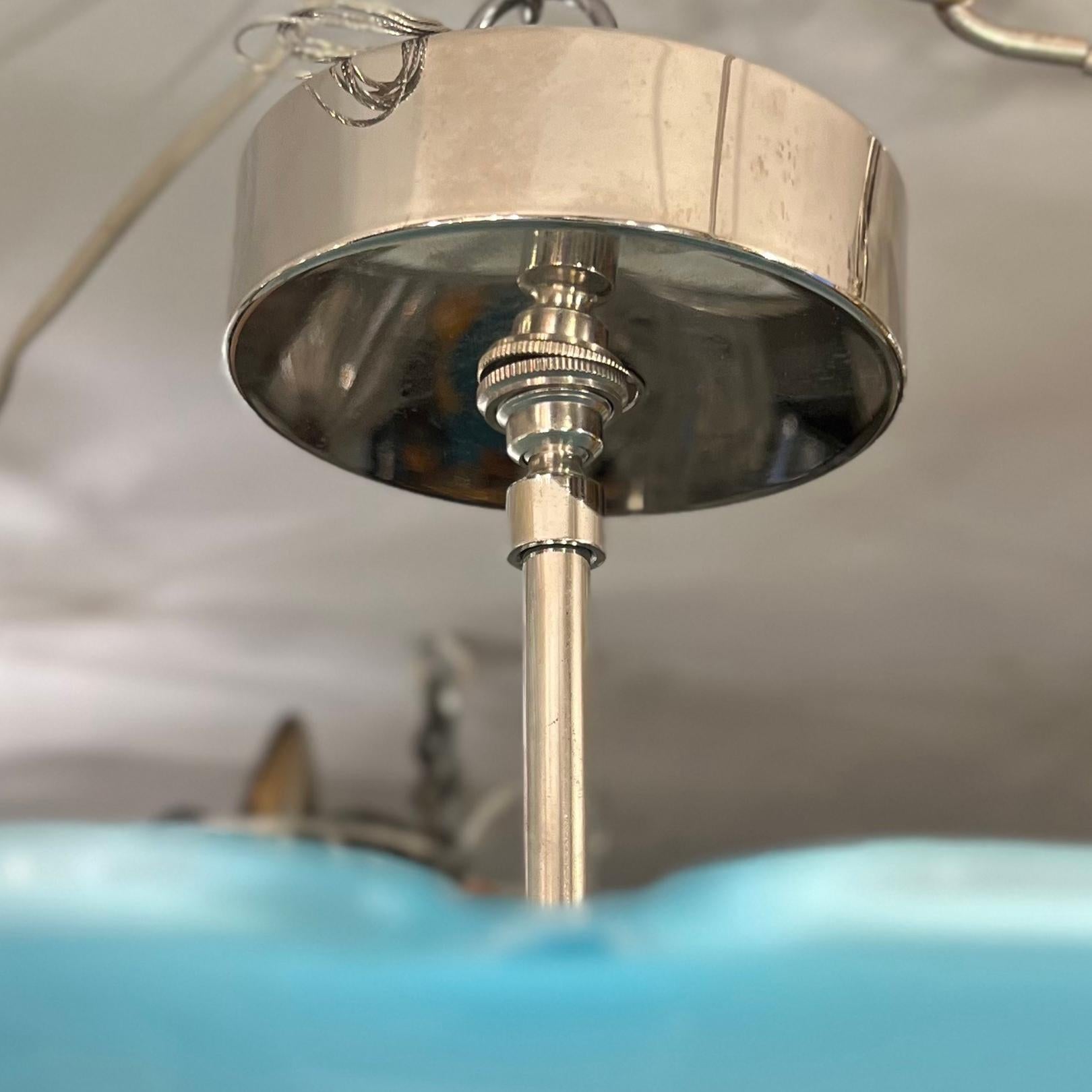 A circa 1930's semi-flushed pendant blue blown glass light fixture with three interior candelabra lights.

Measurements:
Height: 10