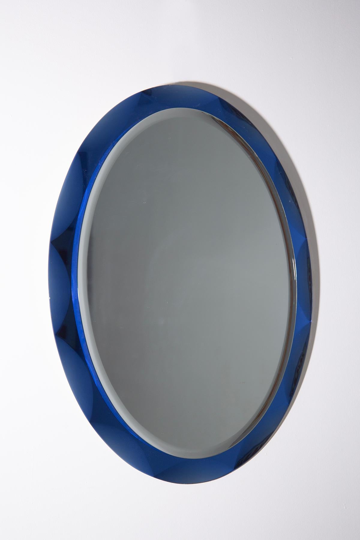 An exquisite wall mirror by MetalVetro Galvorane, crafted in the historic town of Siena, Italy, circa 1975, epitomises the timeless elegance of Italian design. The mirror, with its sinuously shaped oval form, commands immediate attention upon