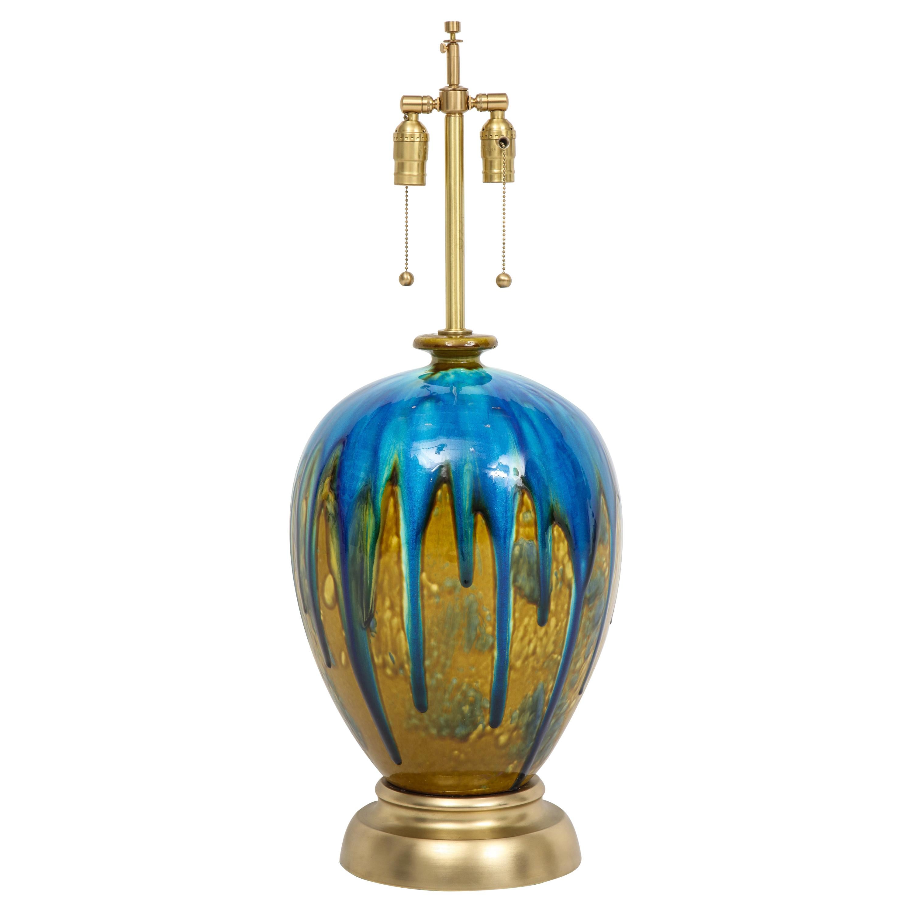 Pair of impressive scale ceramic lamps featuring fantastic drip glaze technique of blues and greens on satin brass bases. Rewired for use in the USA using double pull chain sockets. Mint restored condition.
 