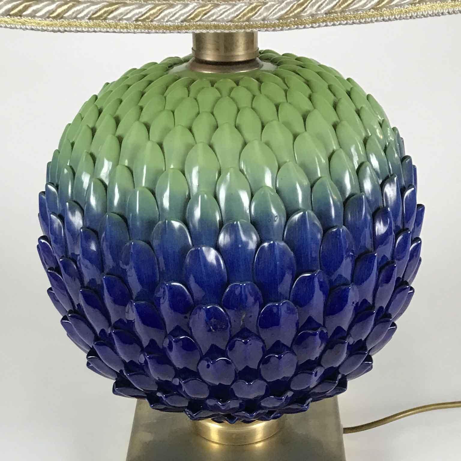 A Mangani porcelain circular table lamp from Italy, Florence. A unique design strobilus lamp, a pine cone or a strobiloid flower hand painted with polychrome decoration, blue and mint green petals of a circular bud flower or inflorescentes set on a