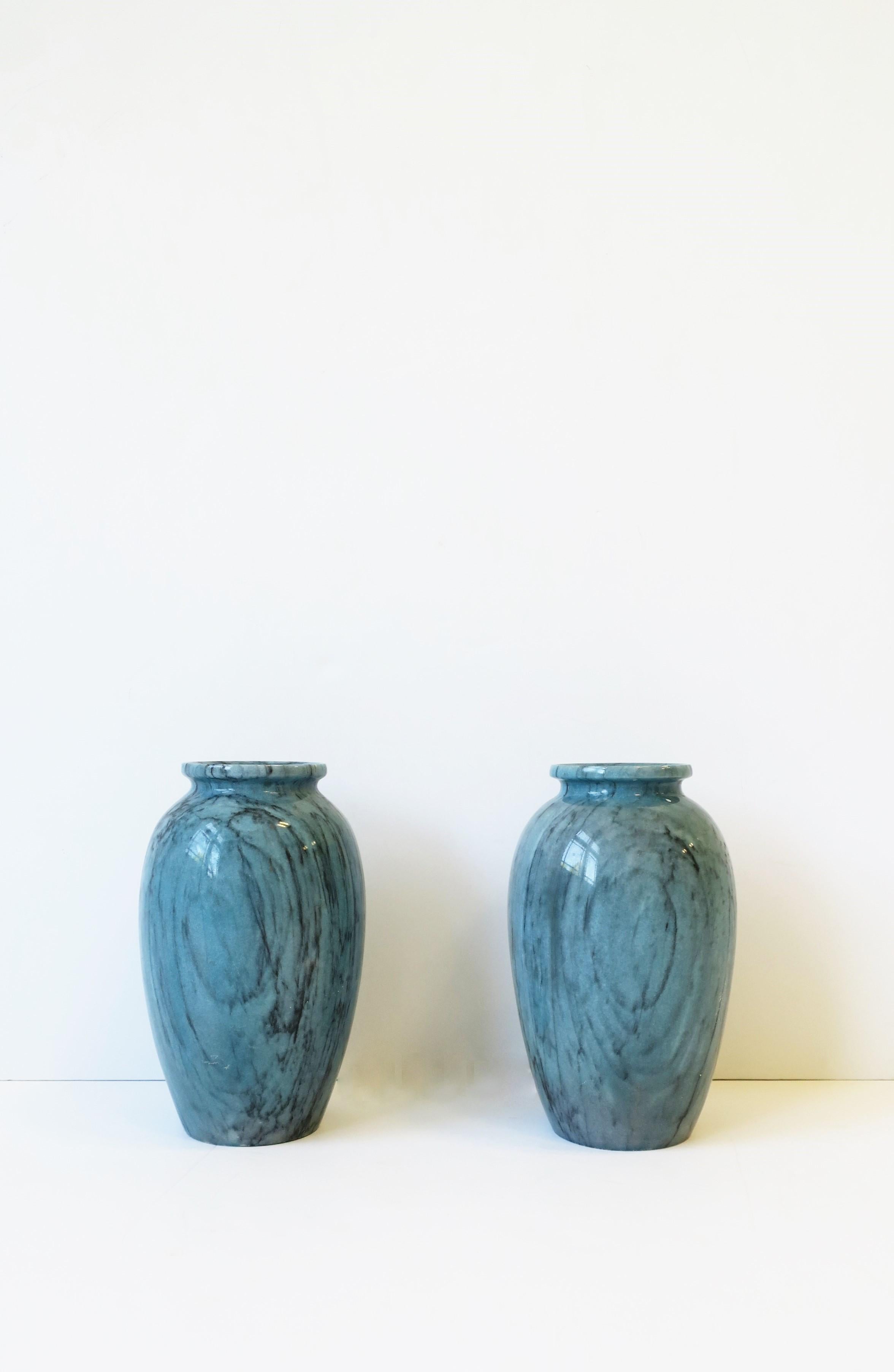 A beautiful and substantial pair of urn style blue marble vases, circa mid-20th century, Italy. Marble has black veining and is beautifully carved and polished smooth. Dimensions: 8.25