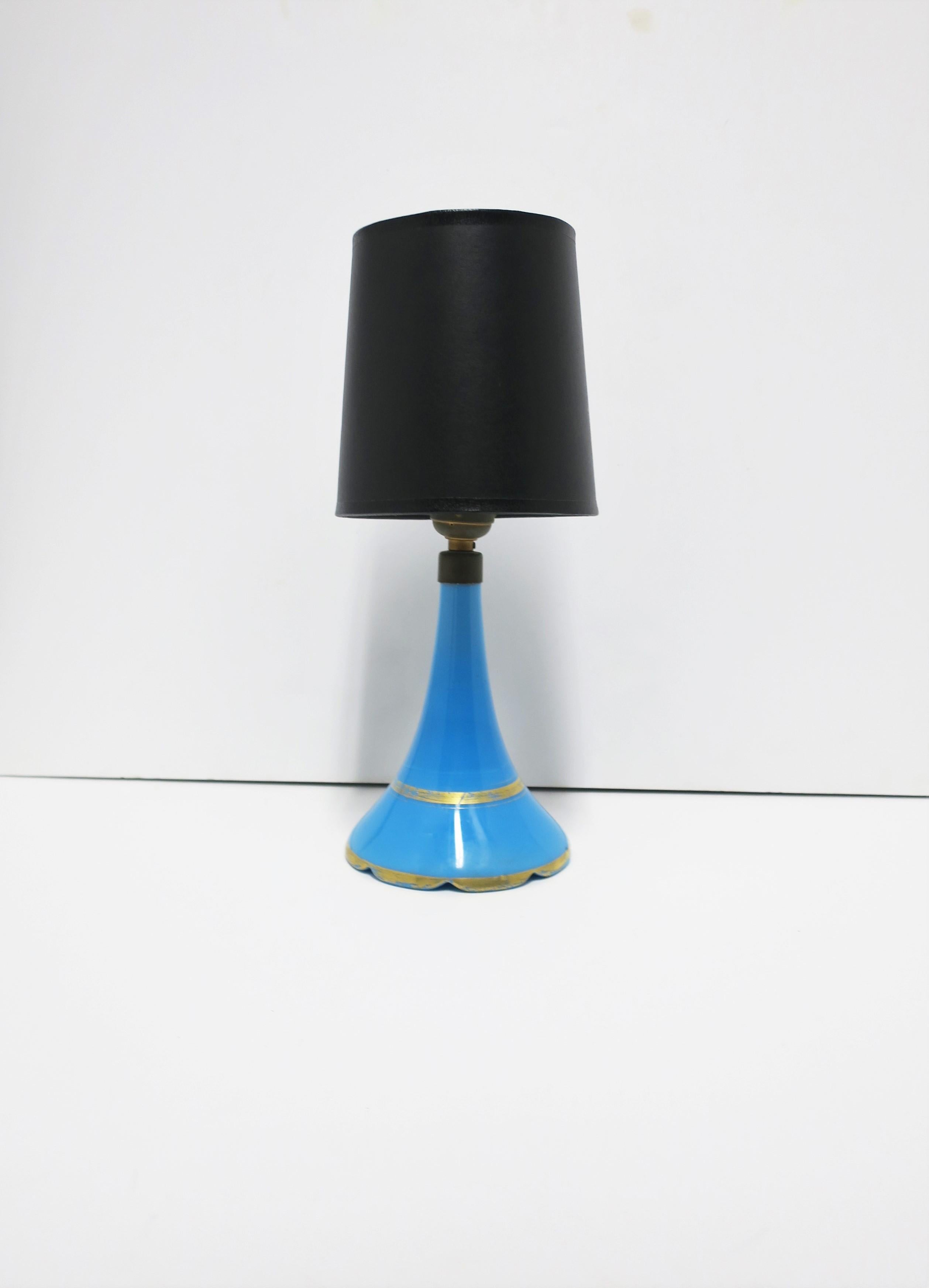 A beautiful Italian blue opaline glass lamp, circa early to mid-20th century, Italy. Lamp is an azure sky-blue with gold detail and scalloped edged base. Lamp includes off-white silk shade. In fine working order as shown in image #8. A great desk or