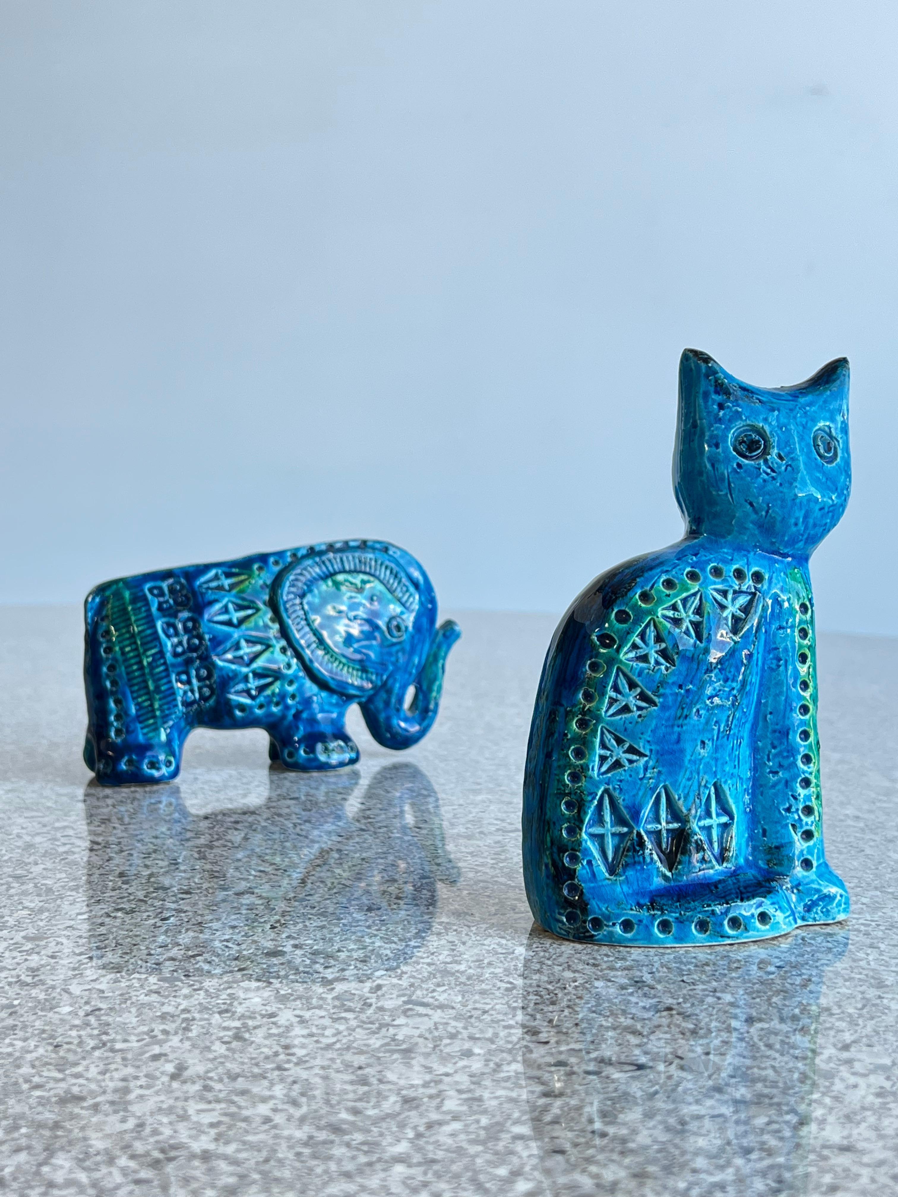 Blue Rimini Italian Flavia Montelutpo ceramic animals 1960s. 
Cat and elephant in ceramic blue glazed. Stamped at the bottom by Flavia Montelupo. 

?Dimensions: 
Cat: H 15 W 9cm 
Elephant: H 10cm W 15cm.