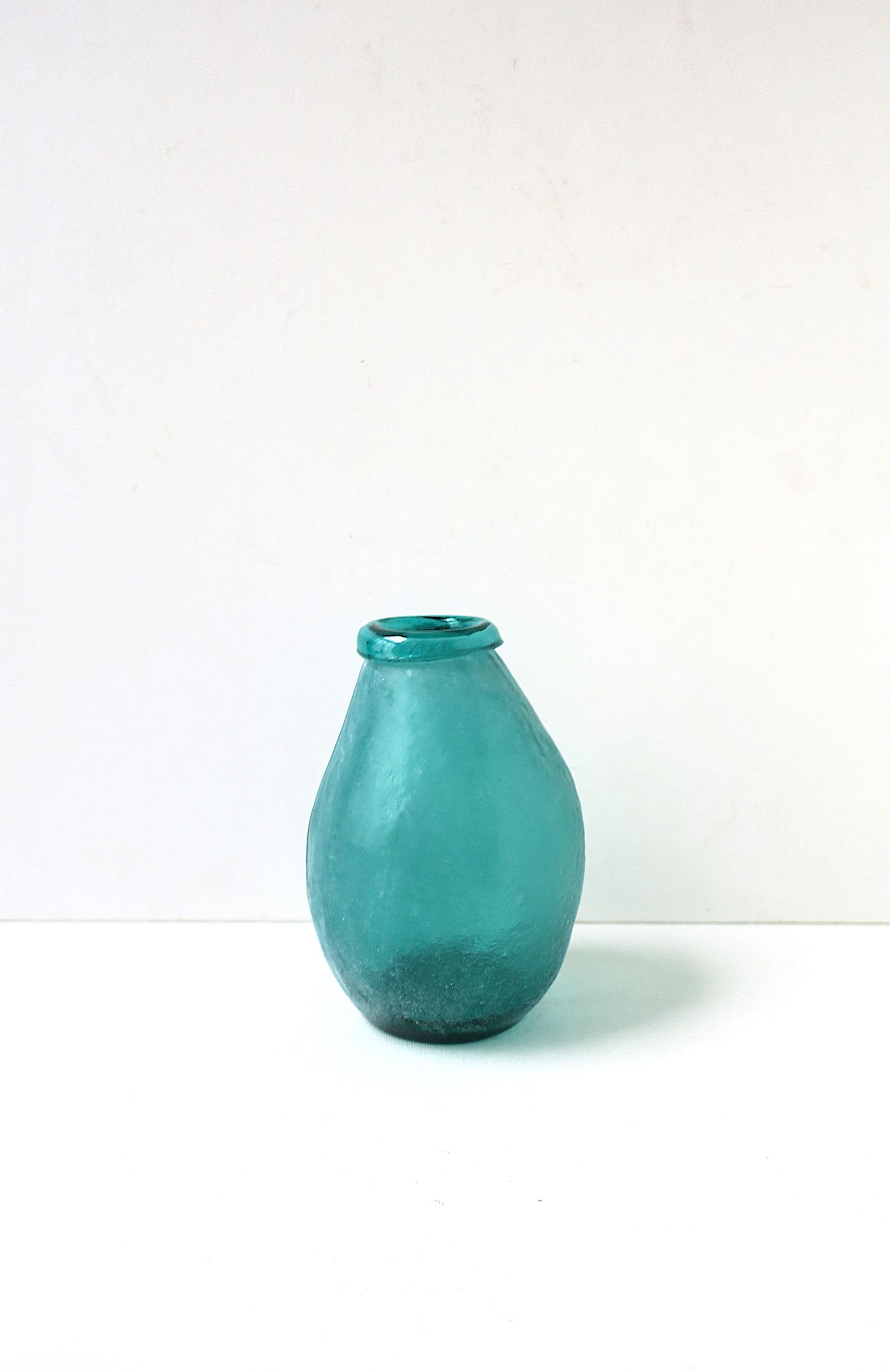 A beautiful Italian turquoise blue 'Scavo' blown art glass vase, in a rustic/organic design, circa late-20th century, Italy. Scavo art glass has a matte textured surface. This vase has a turned lip edge revealing its smooth (internal) surface.