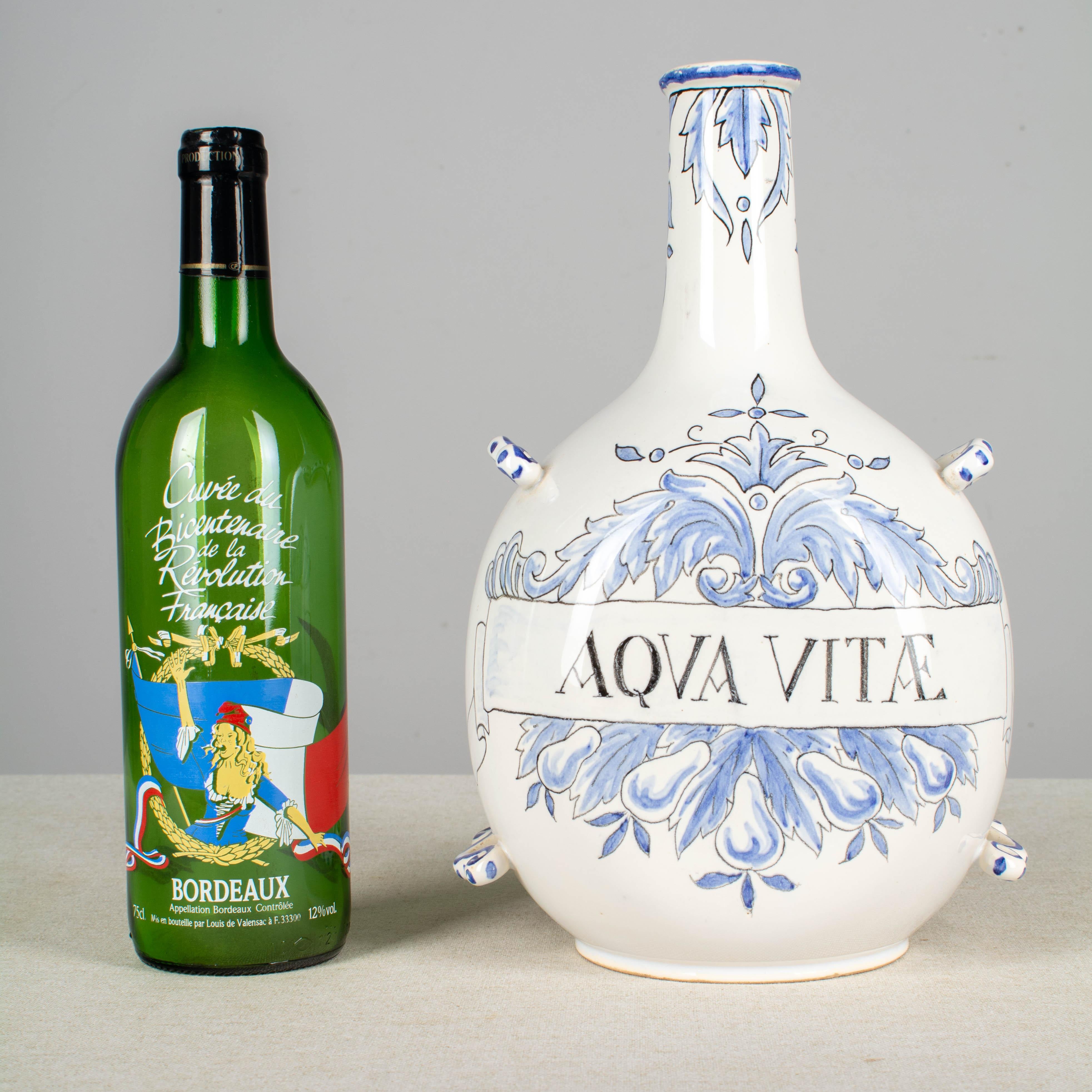 An Italian ceramic jug, or bottle, hand painted in pale blue with the label 