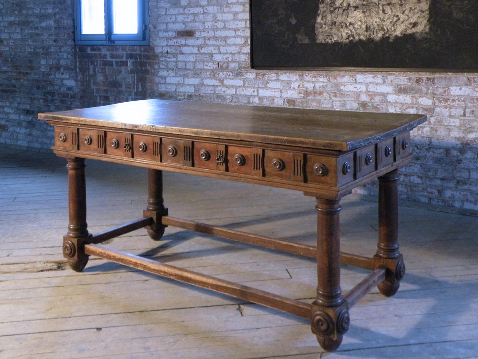 Italian (Bolognese) late 16th century center table or desk of late Renaissance /early Baroque Form, the rectangular top above a frieze decorated with turned roundels all around and containing two drawers on one side, supported by four columnar legs