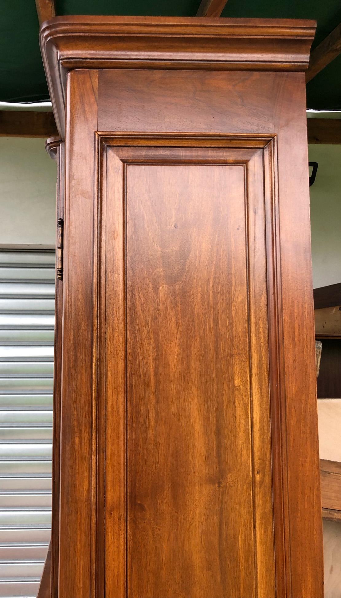 Italian bookcase showcase in solid walnut with four doors with ground glass and four drawers. 
The glass top is detached from the base which has another four drawers and four doors.
 All visible wood is in solid national walnut. 
The internal
