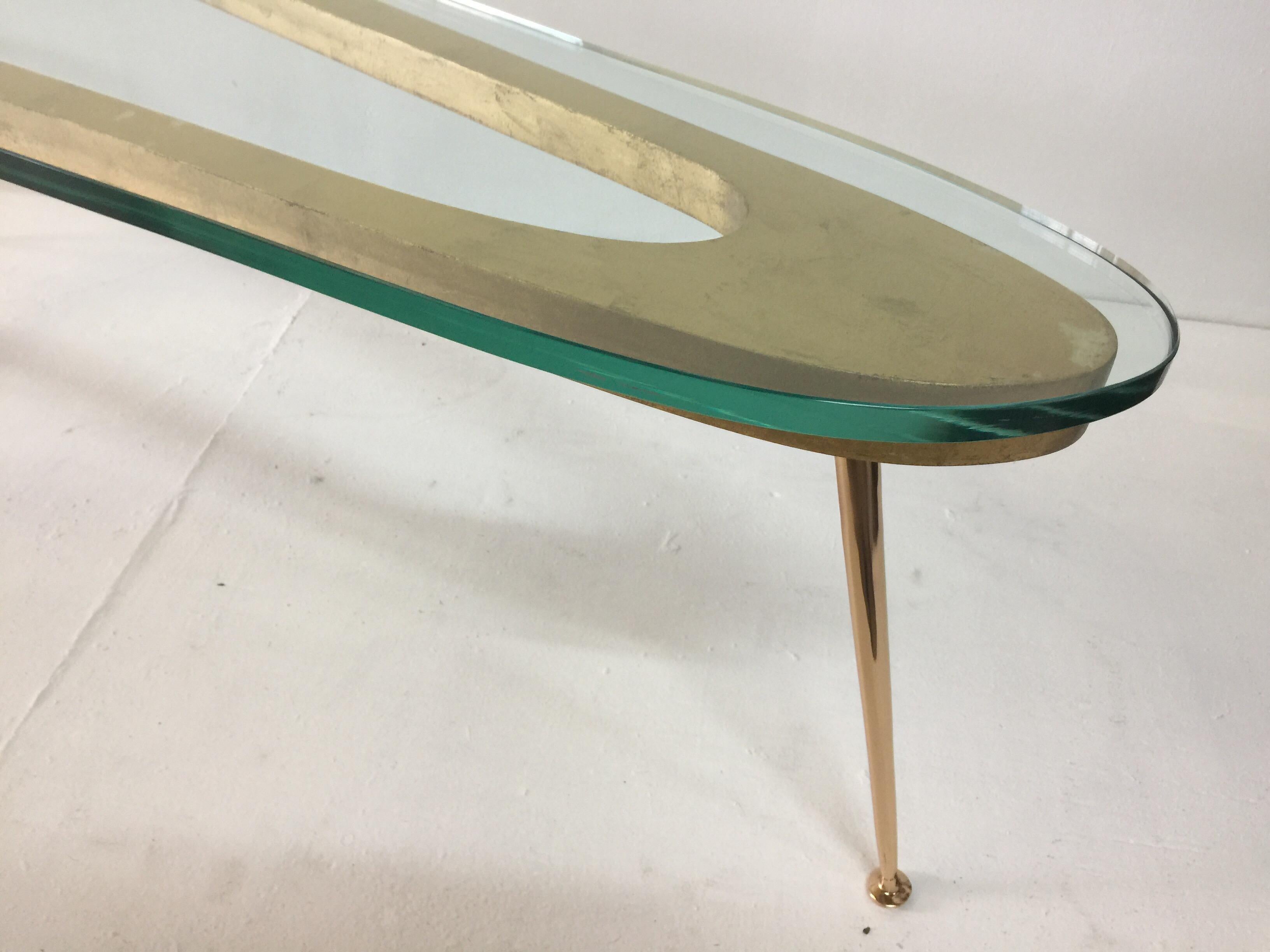 Extra long tapering bronze legs with a stencil cut boomerang top design and a 3/4 inch glass top. This is truly the best of Italian midcentury design. Gilded wood has spots and signs of age - variations in tone, etc.