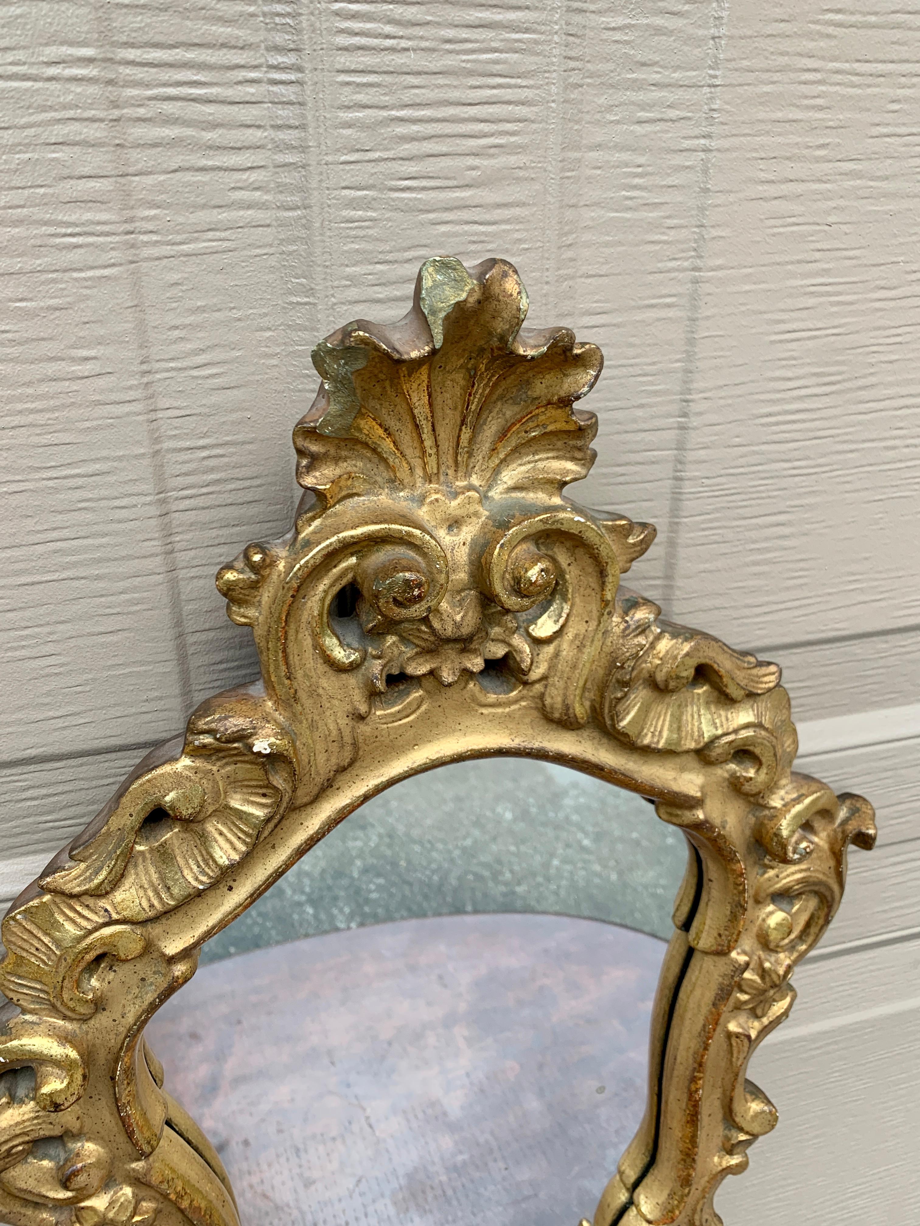 A gorgeous Rococo Baroque style gilt wood framed mirror

Italy, Circa 1940s

Measures: 15