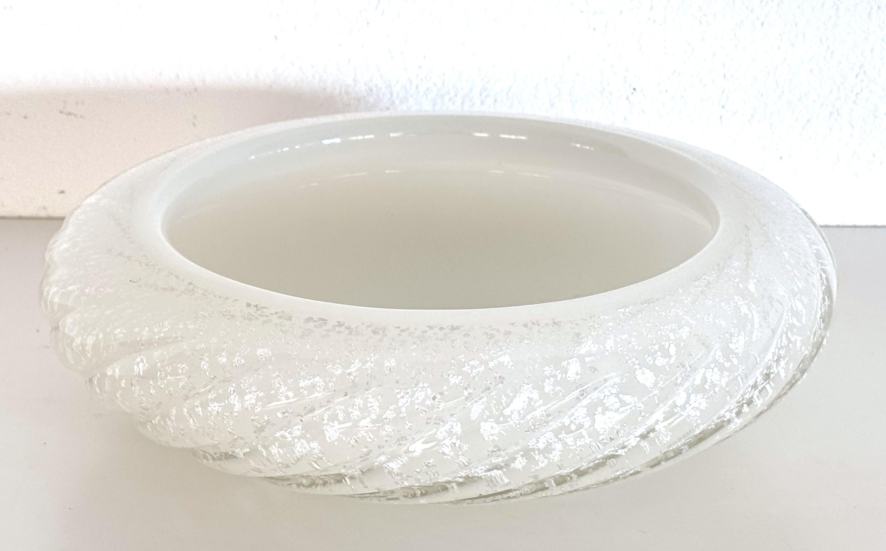 Italian Bowl or Vide-Poche in Murano Twisted Glass by Seguso, 1970s

Beautiful glass bowl made of shiny, twisted Murano glass using a two-tone technique.
The color of the glass is snow-white inside, and transparent outside with silver glitter in the