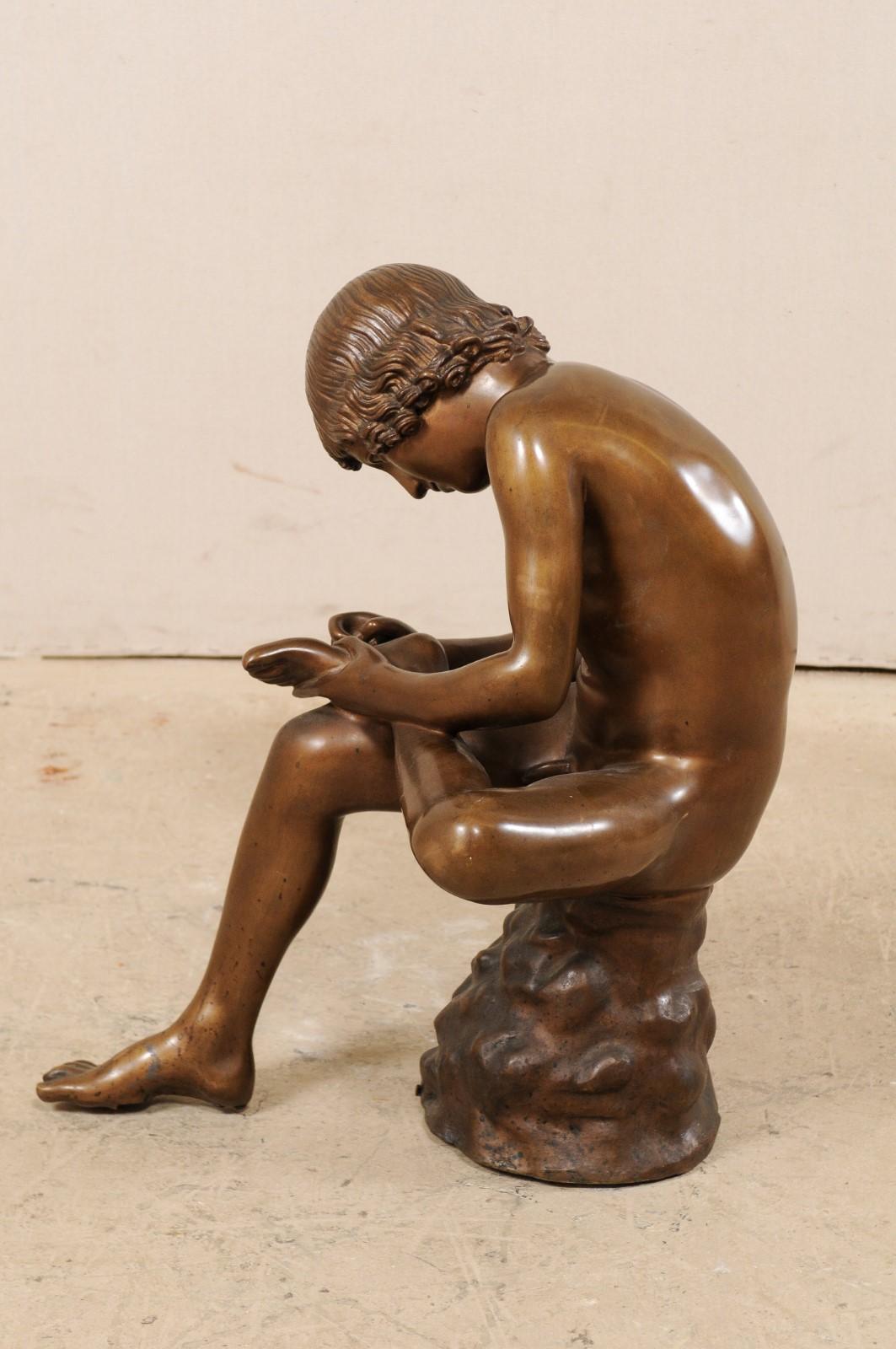 boy removing thorn sculpture