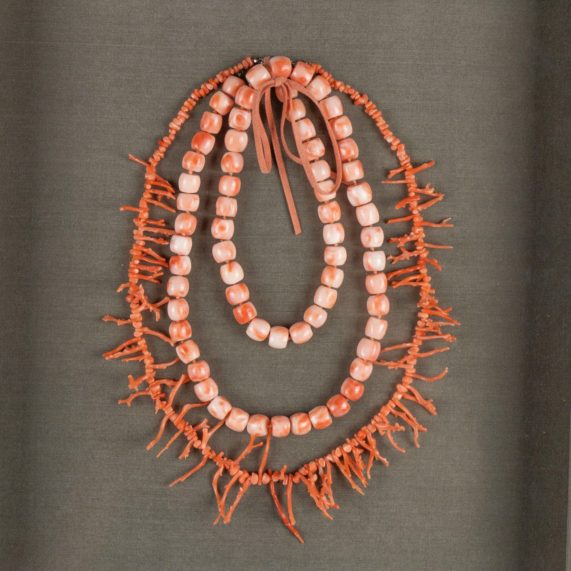 Branch coral and bead coral necklaces mounted on green linen and in a shadow box frame.

Italy, circa 1930.