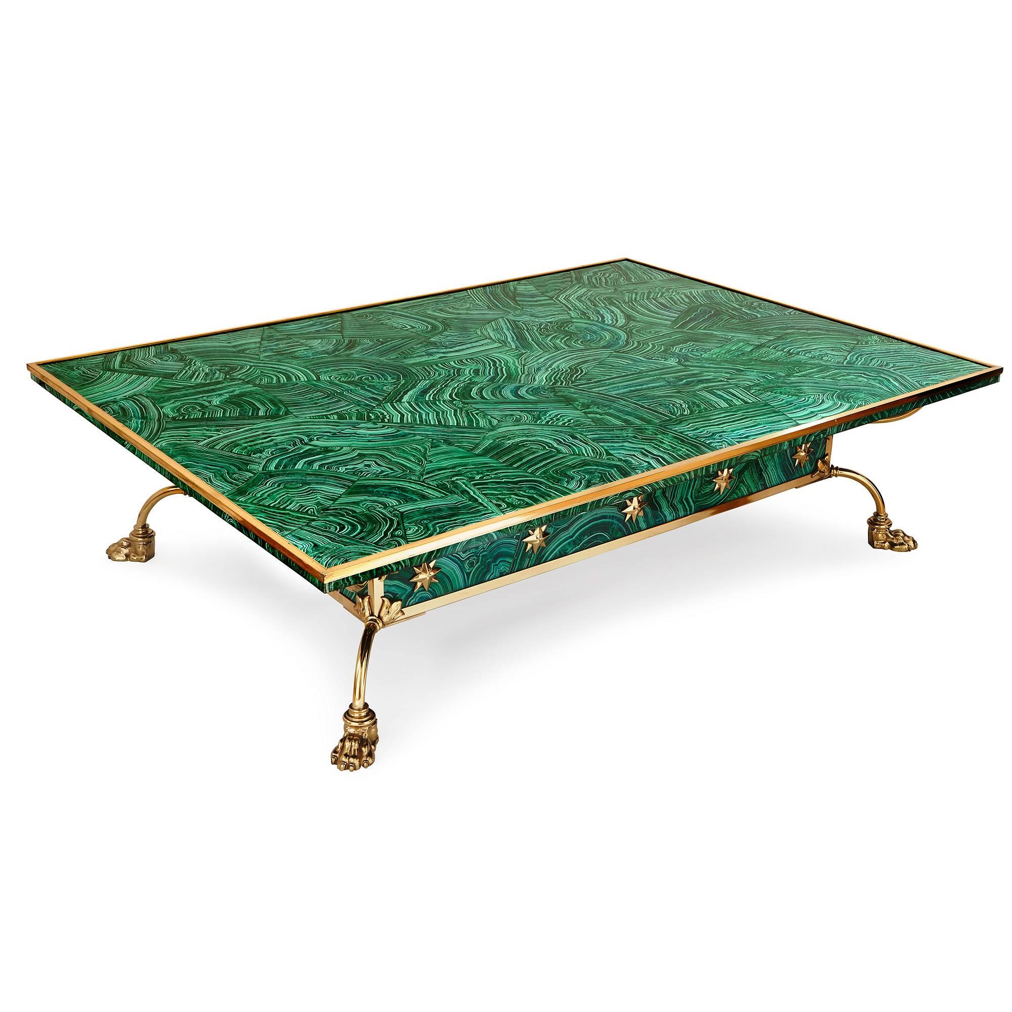 This bright green coffee table will make an impressive statement in a modern interior. Built with a cool green faux malachite veneer and mounted with brass, the table radiates color, light, and style. 

It is rectangular in shape and set on four